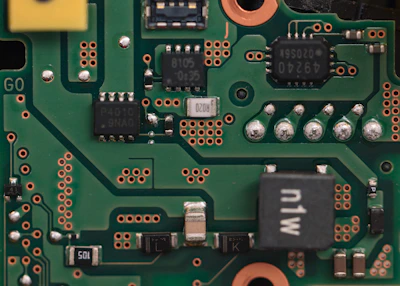 Close-up of a green circuit board with electronic components.