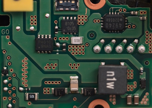 Close-up of a green circuit board with electronic components.