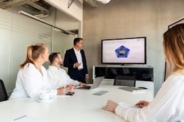 Business meeting with a presenter and colleagues in office.