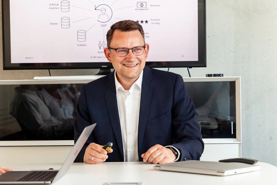 Smiling man in a suit in a modern office