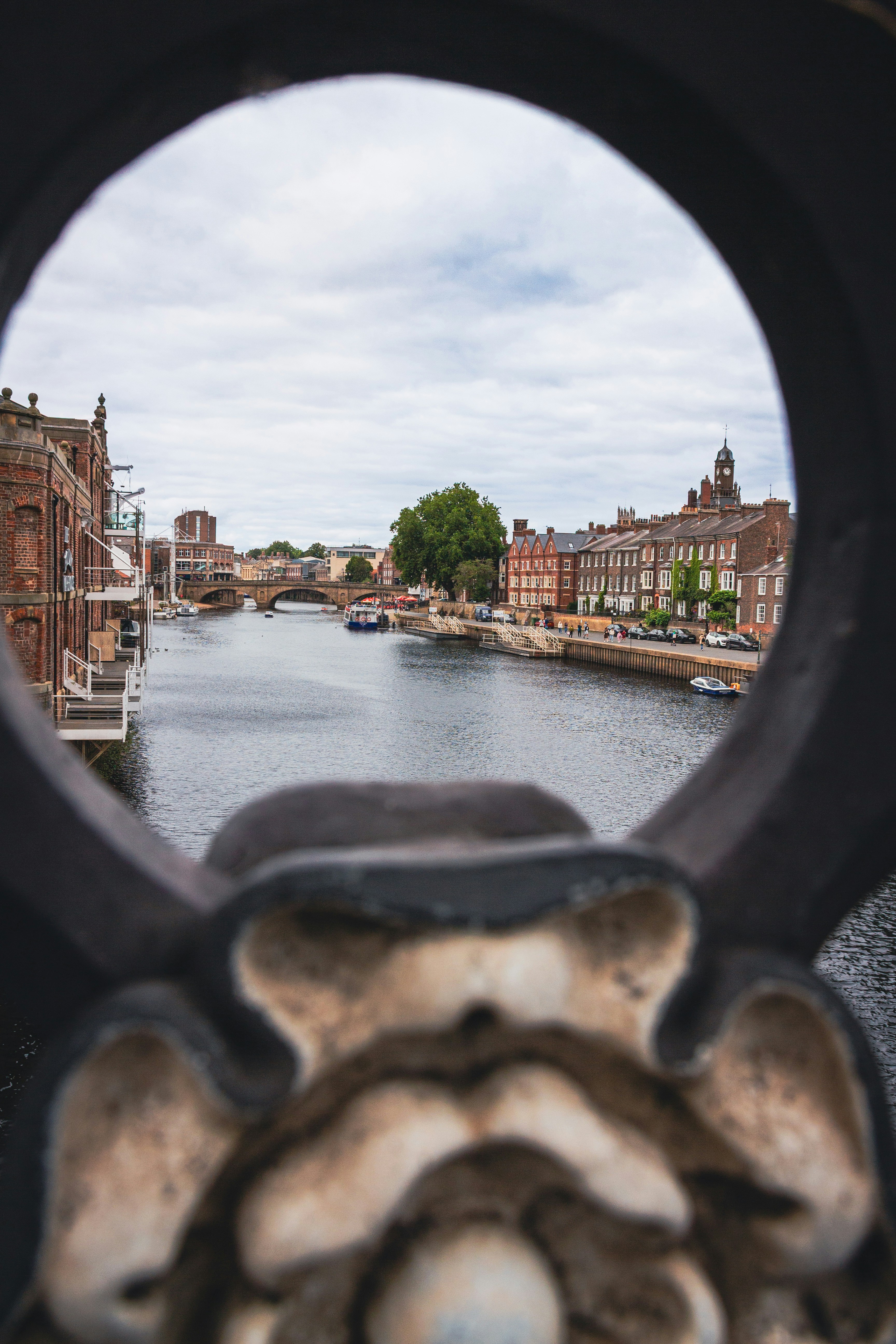 River flowing through historic buildings with bridge