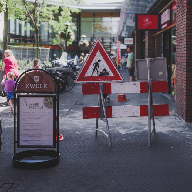 Road construction sign and barrier on sidewalk