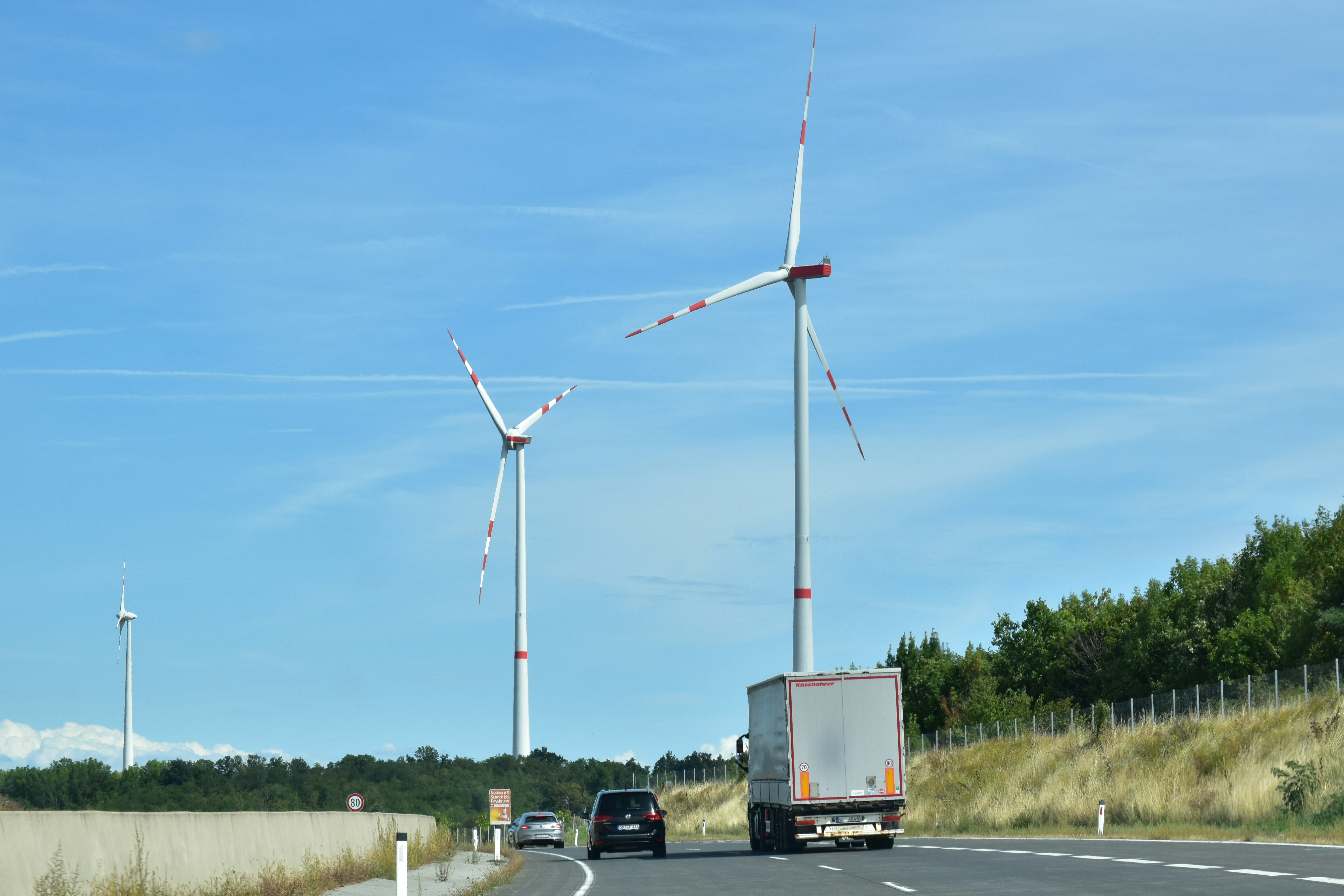 Image of a wind turbine and an electric vehicle - copper bars