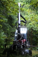 Forestry harvester machine working in a dense forest.