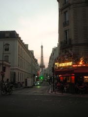 Eiffel tower visible down a street in paris