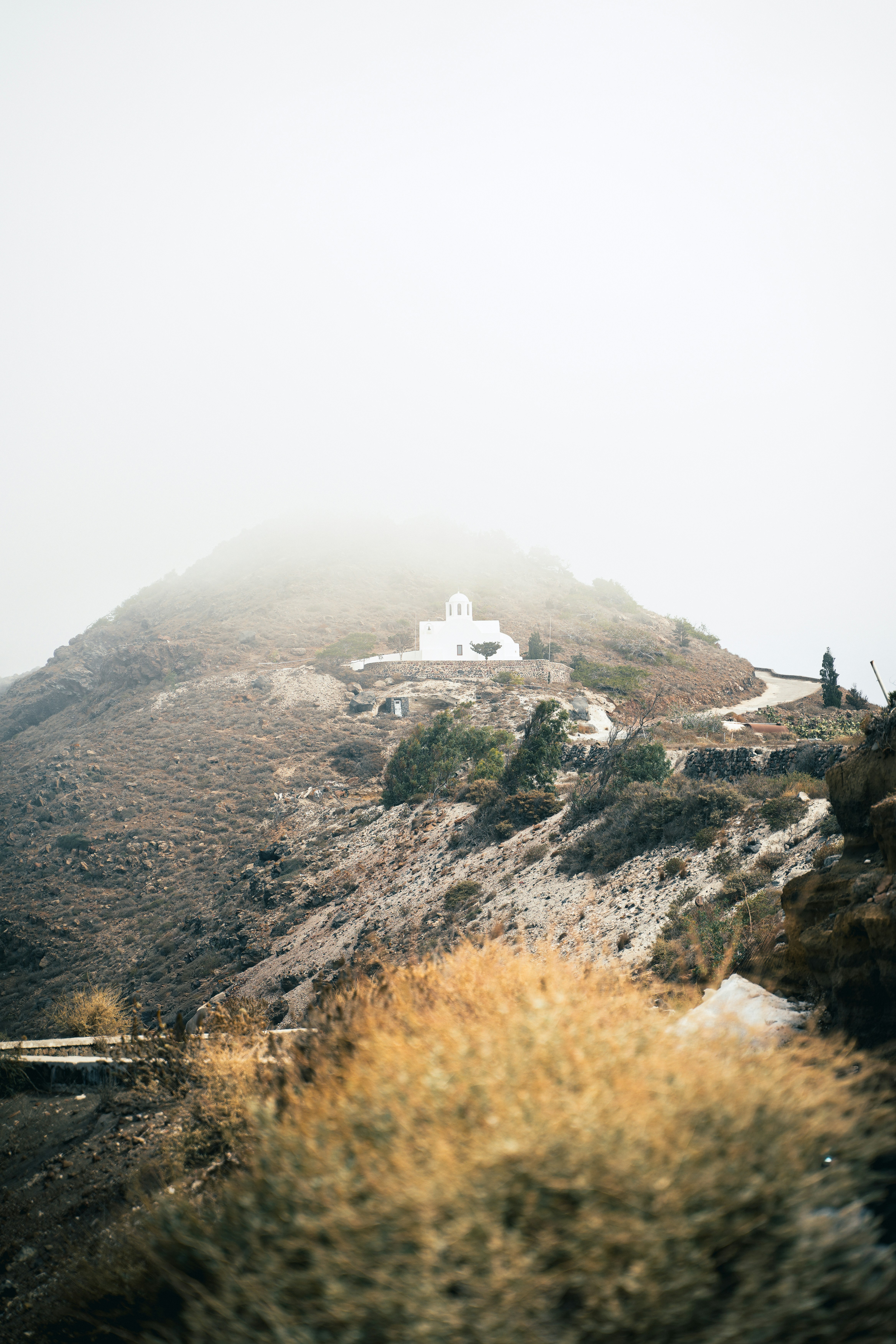 White church on a misty mountain peak