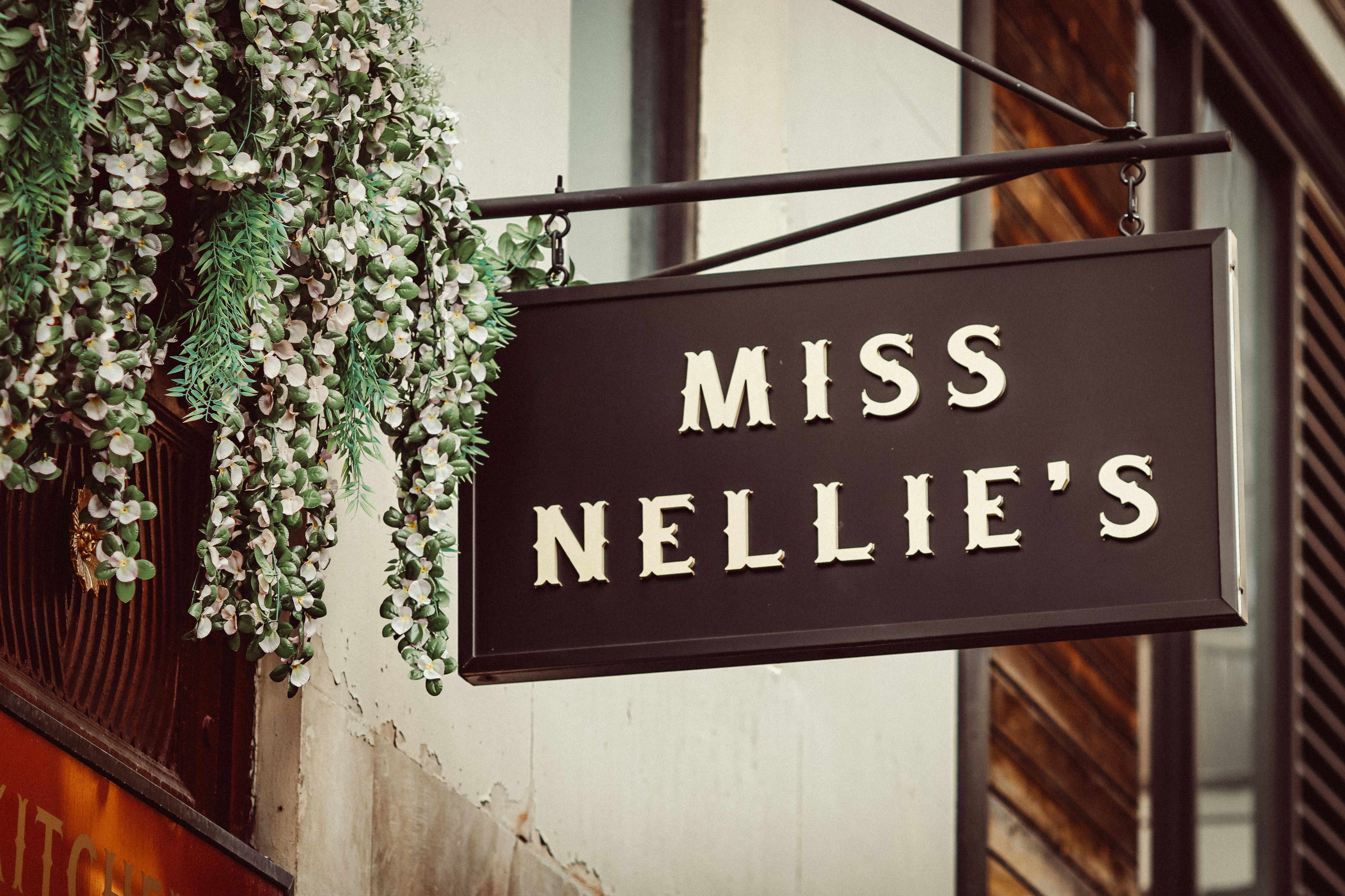 A sign reads miss nellie's hanging outside.