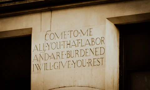 Engraved text on a stone pillar offers rest