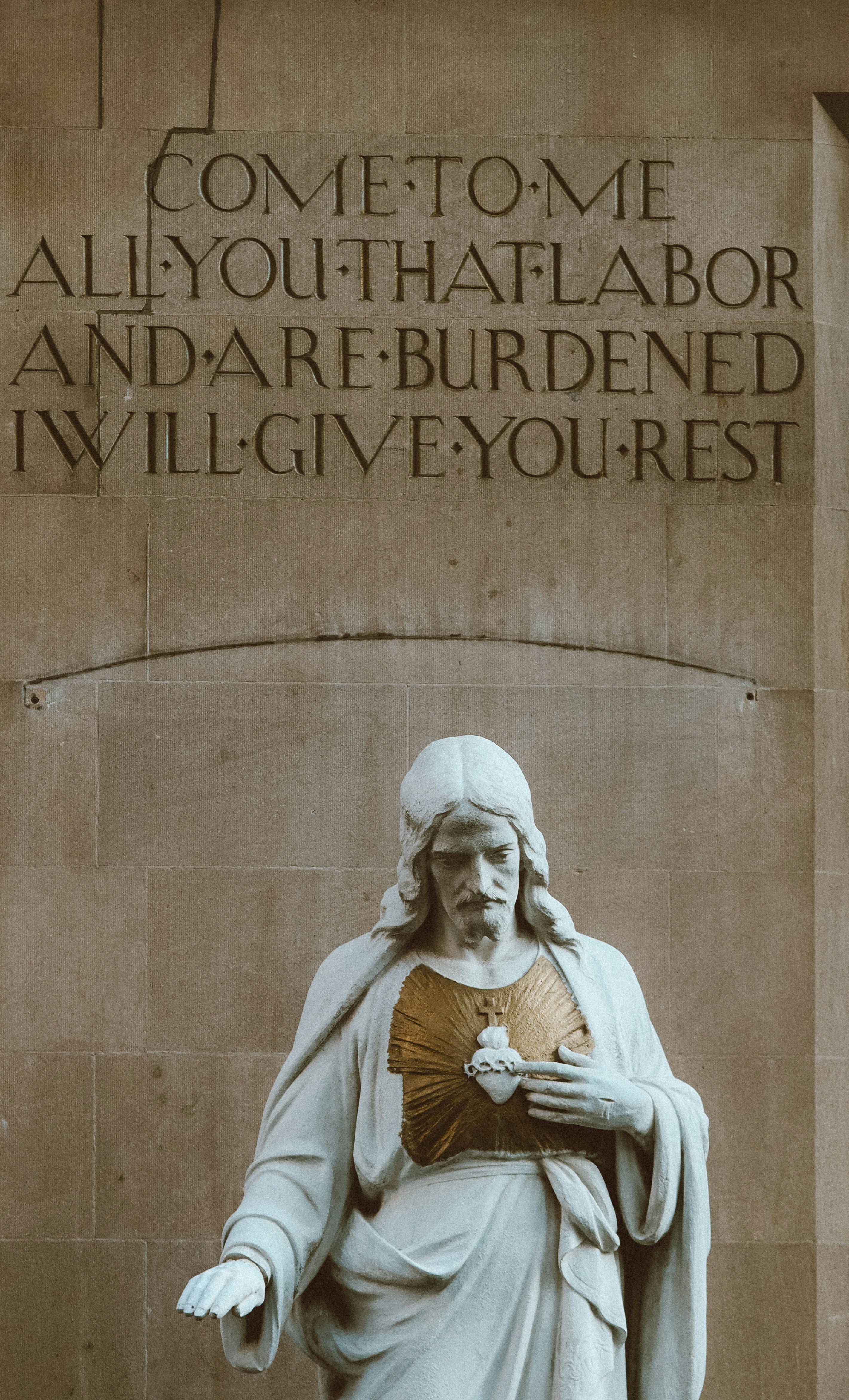 Statue of jesus with inscription above