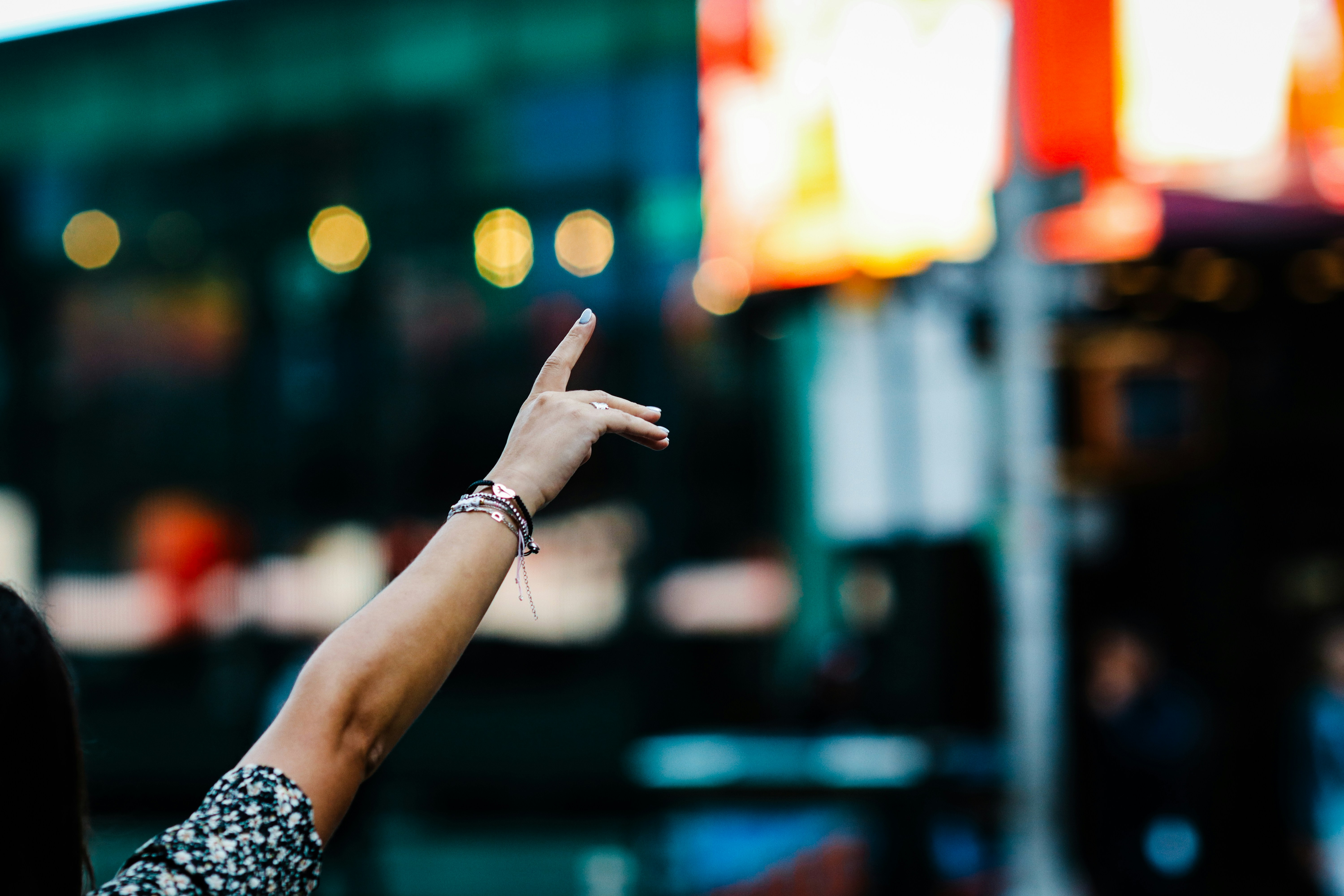 Arm reaching out in a blurry city at night city