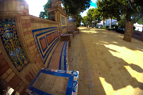 Ornate tiled bench in a sunny park path