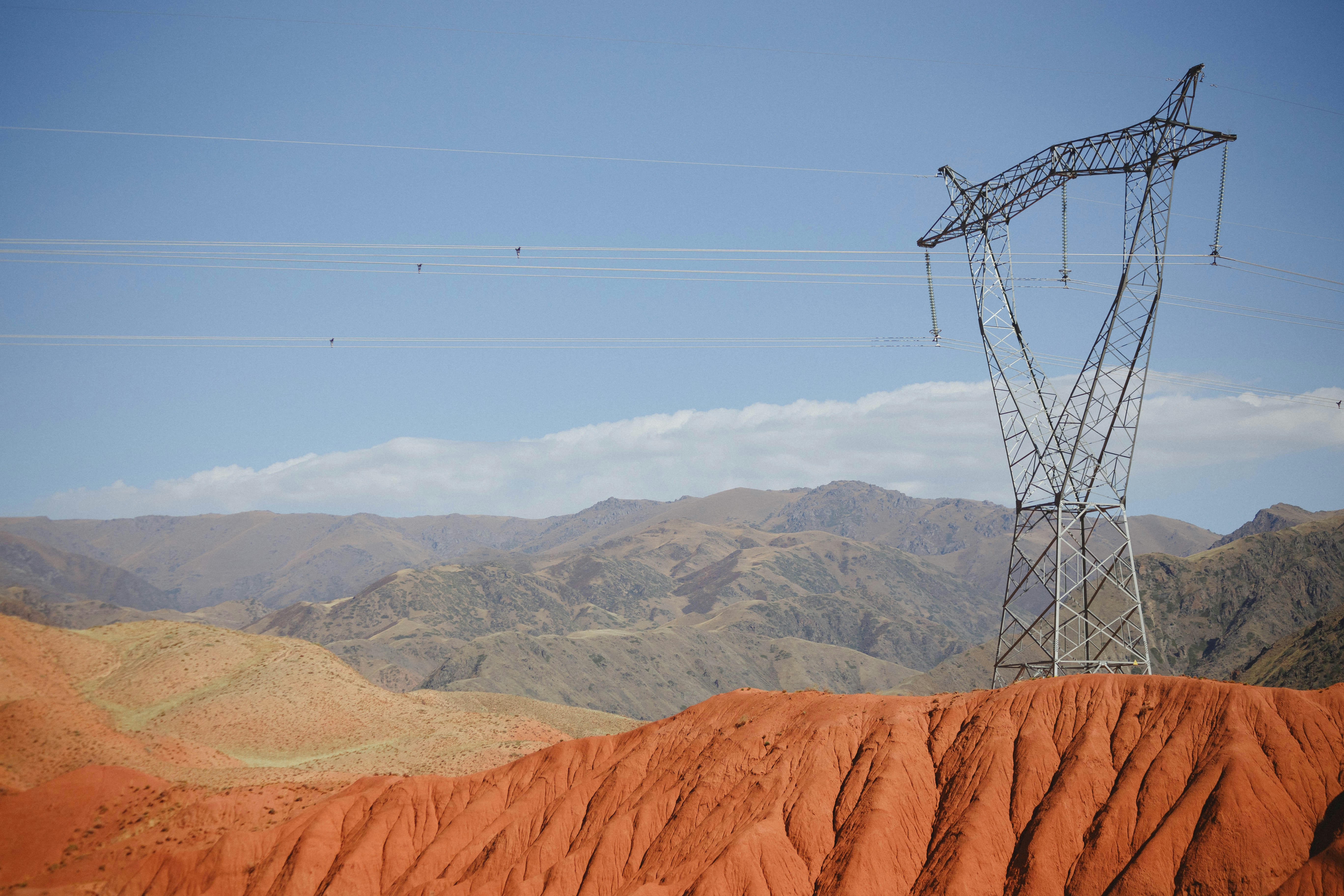 Power line tower in arid desert landscape