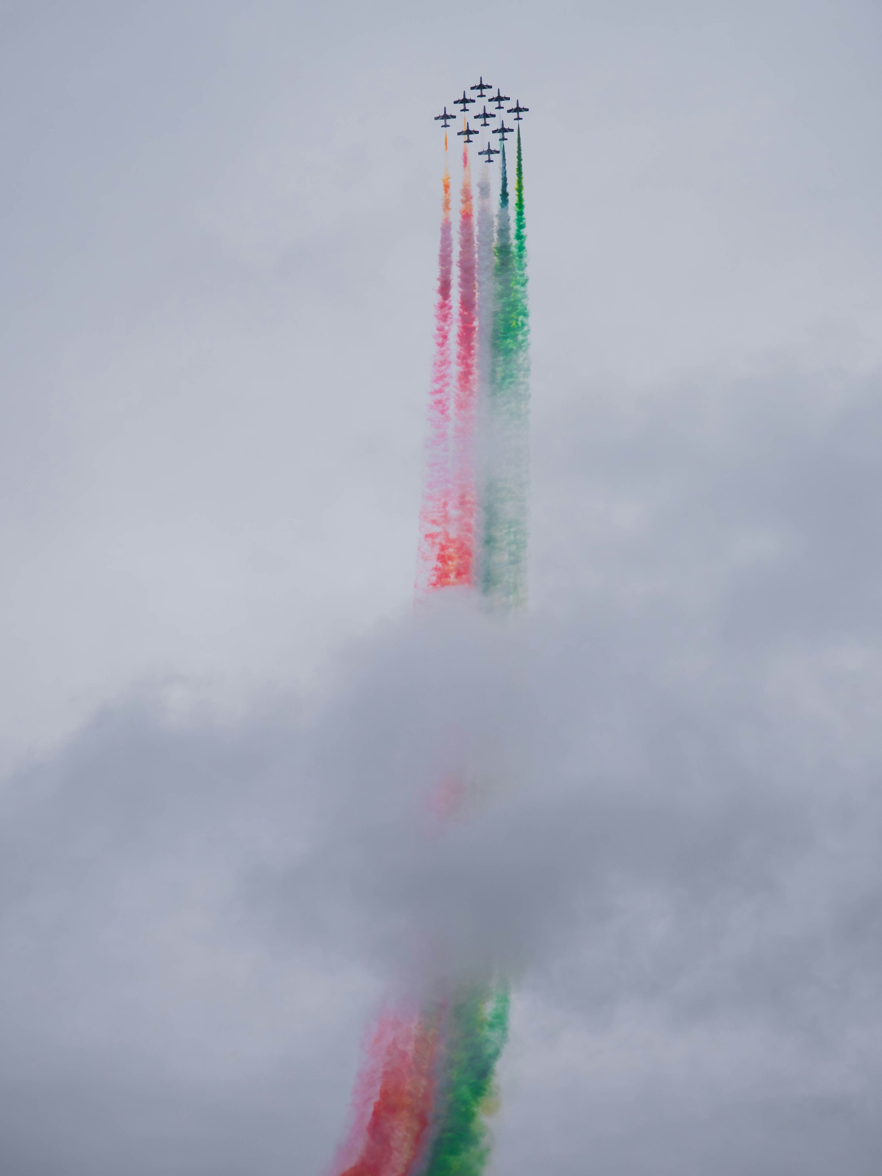 Jets fly in formation leaving colorful smoke trails.
