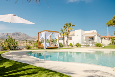 Luxury resort with pool and cabana on sunny day