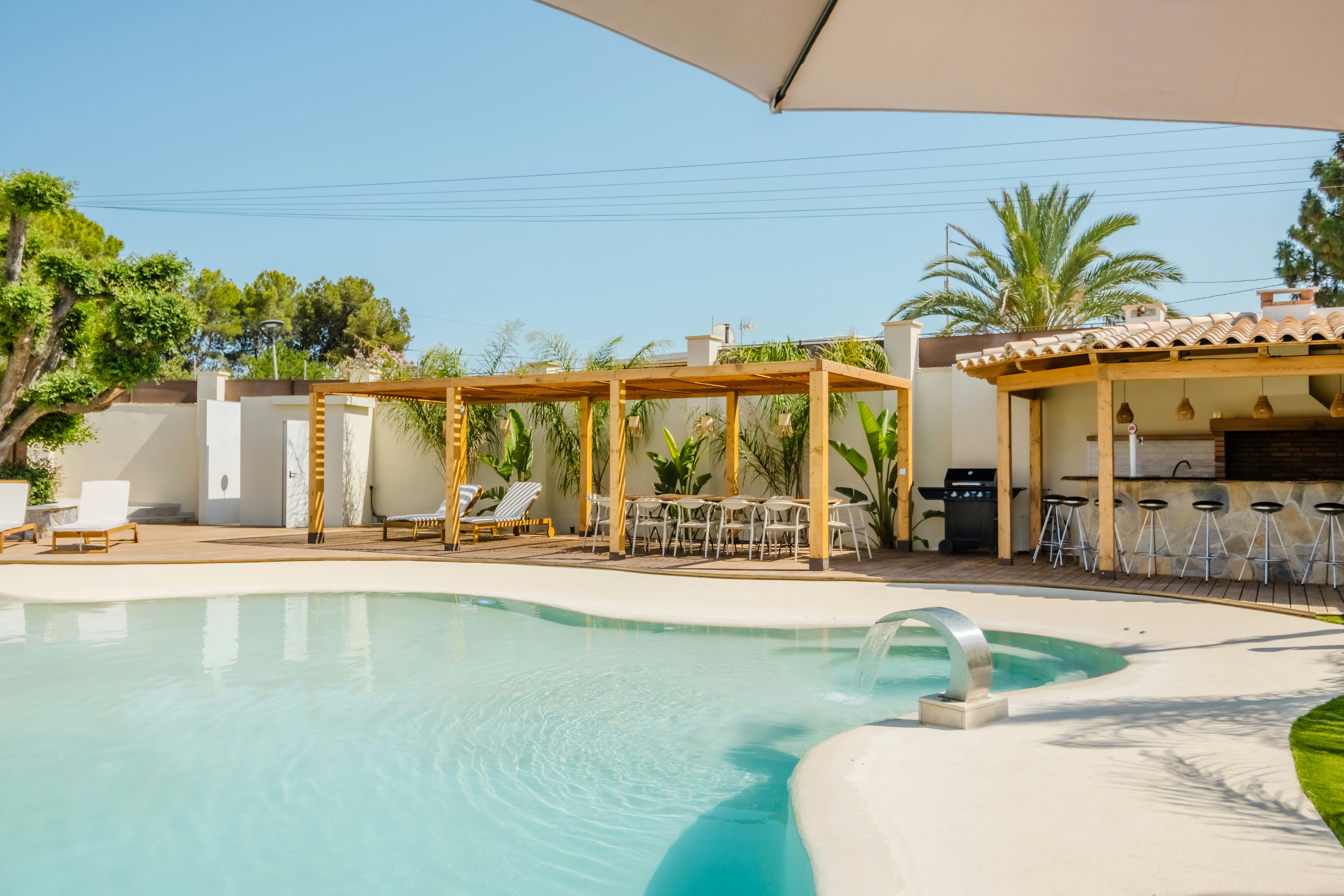 Resort pool area with bar and dining space