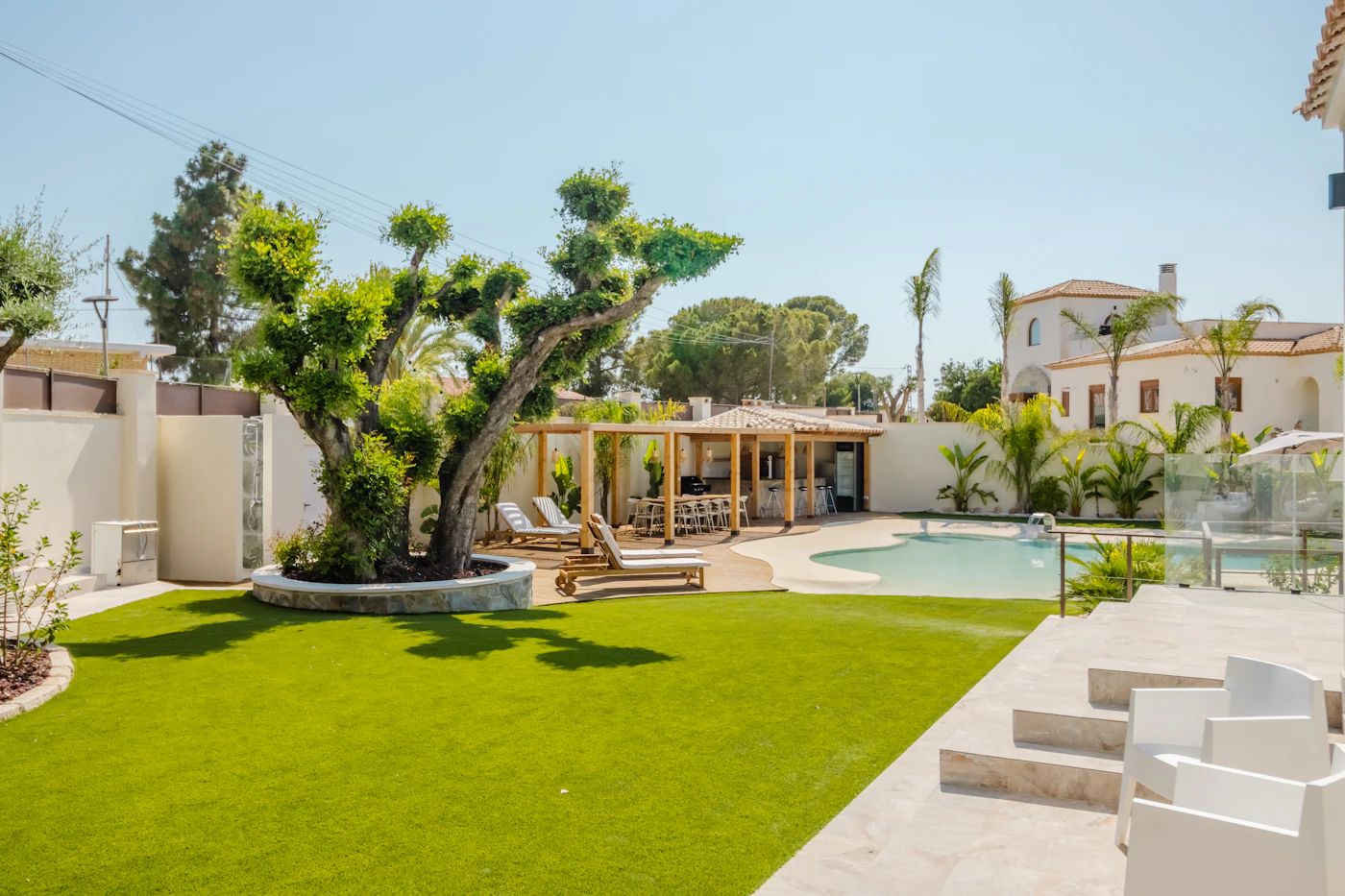 A whitewashed Ibizan villa with olive trees