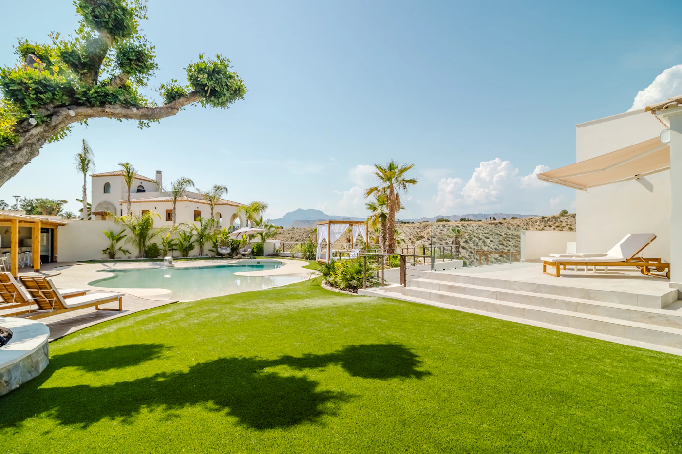 Villa with pool surrounded by a manicured lawn
