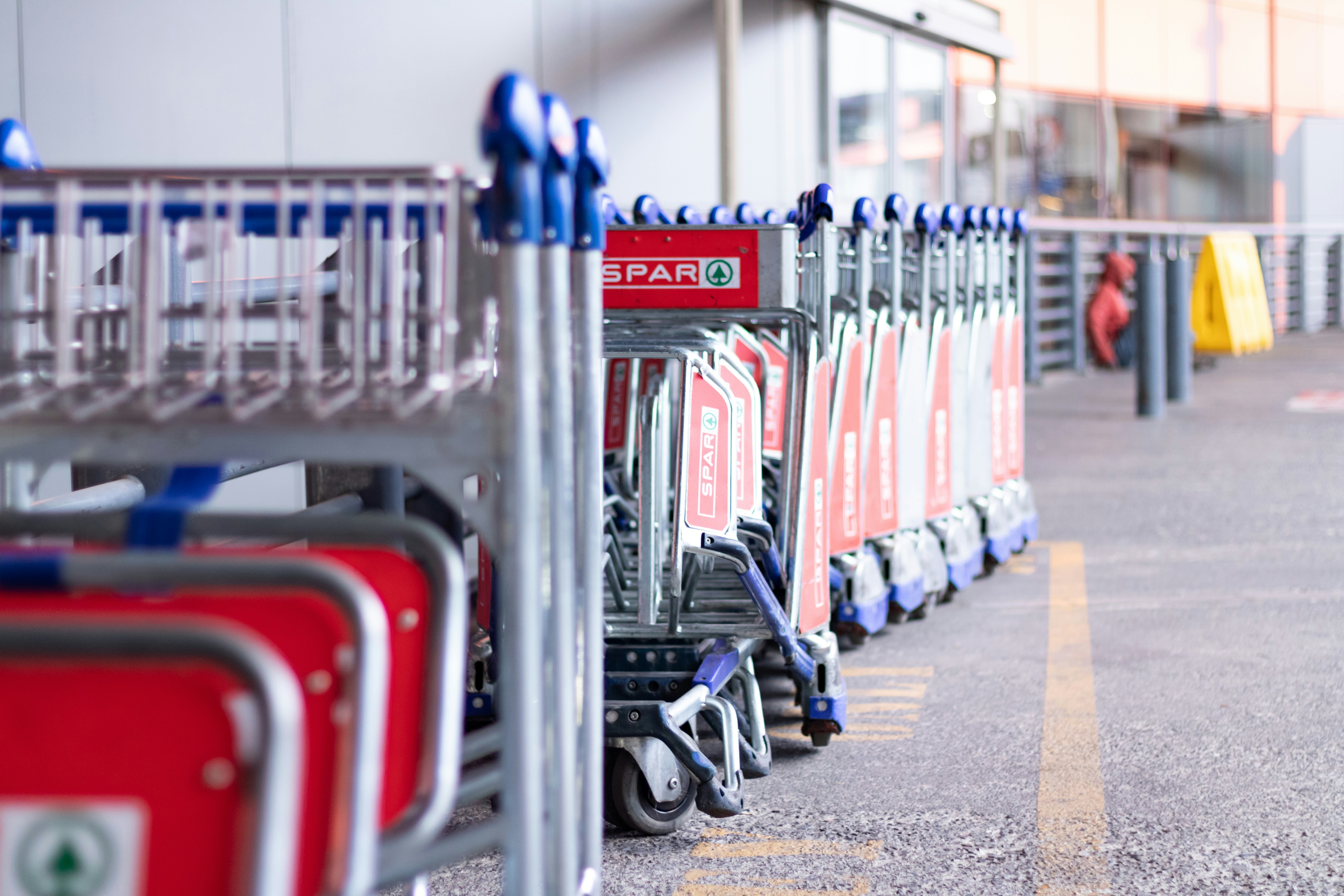 Shopping carts lined up outside a store.