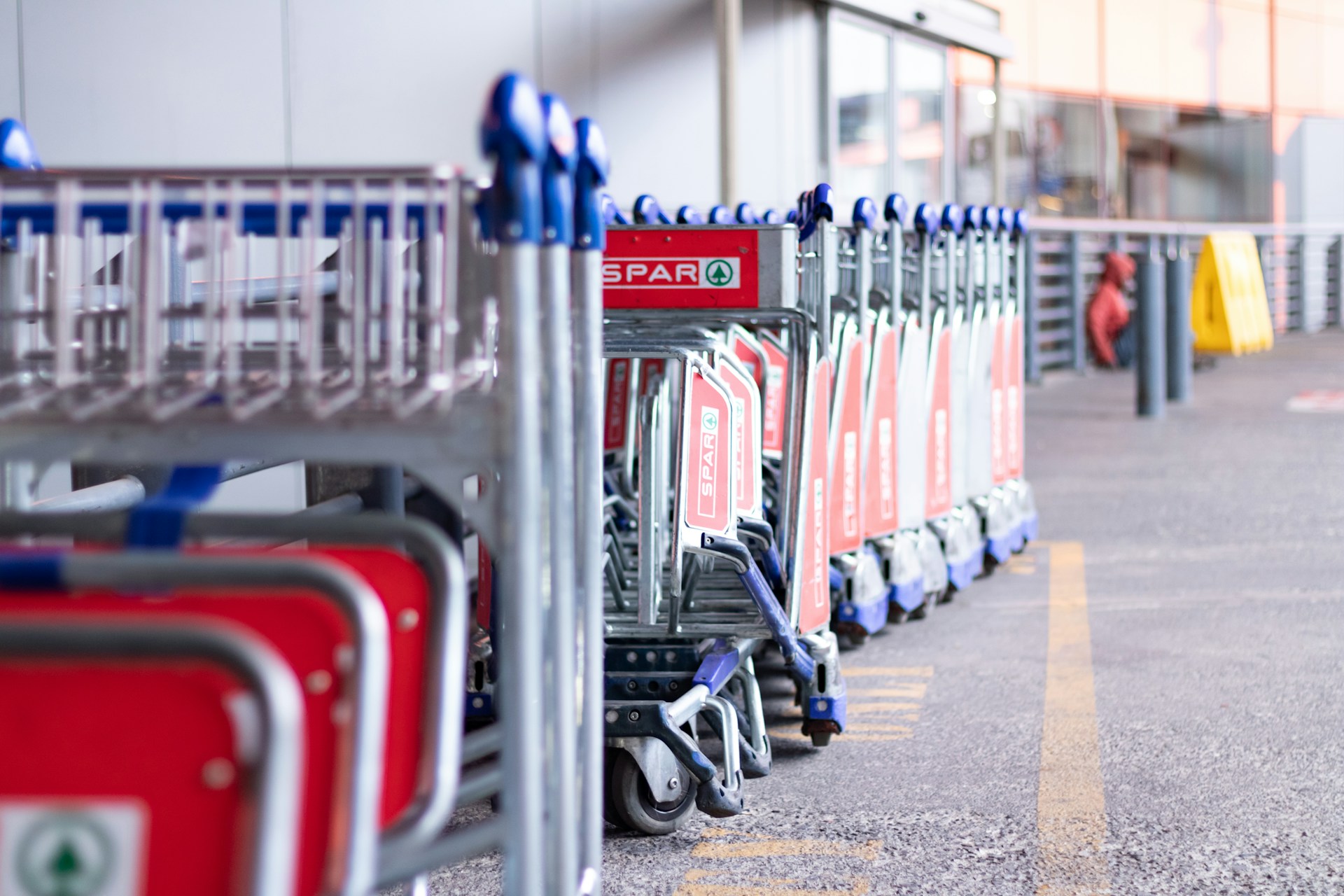 Shopping carts lined up outside a store.