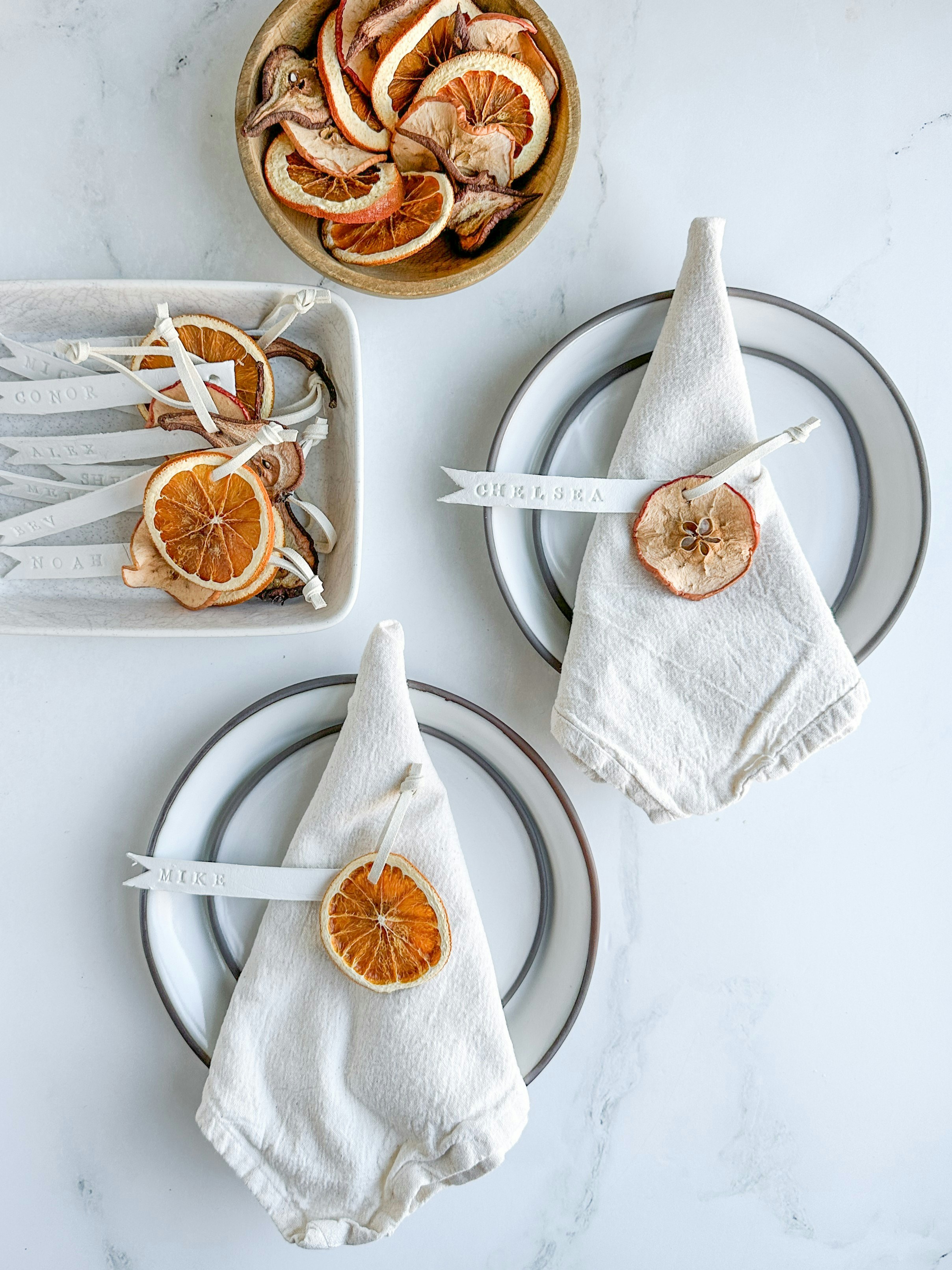 Dried fruit slices decorate napkins on plates