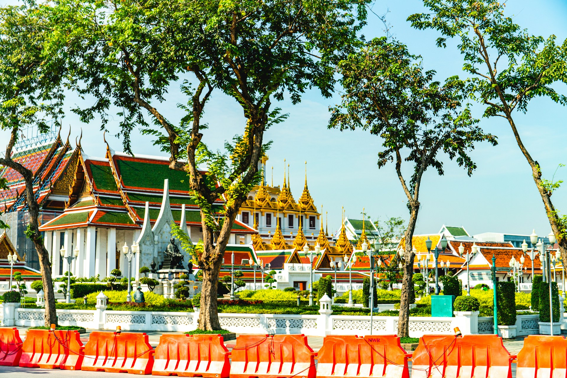 Ornate temple buildings with golden roofs and trees.