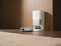 White robot vacuum cleaner docked at charging station.
