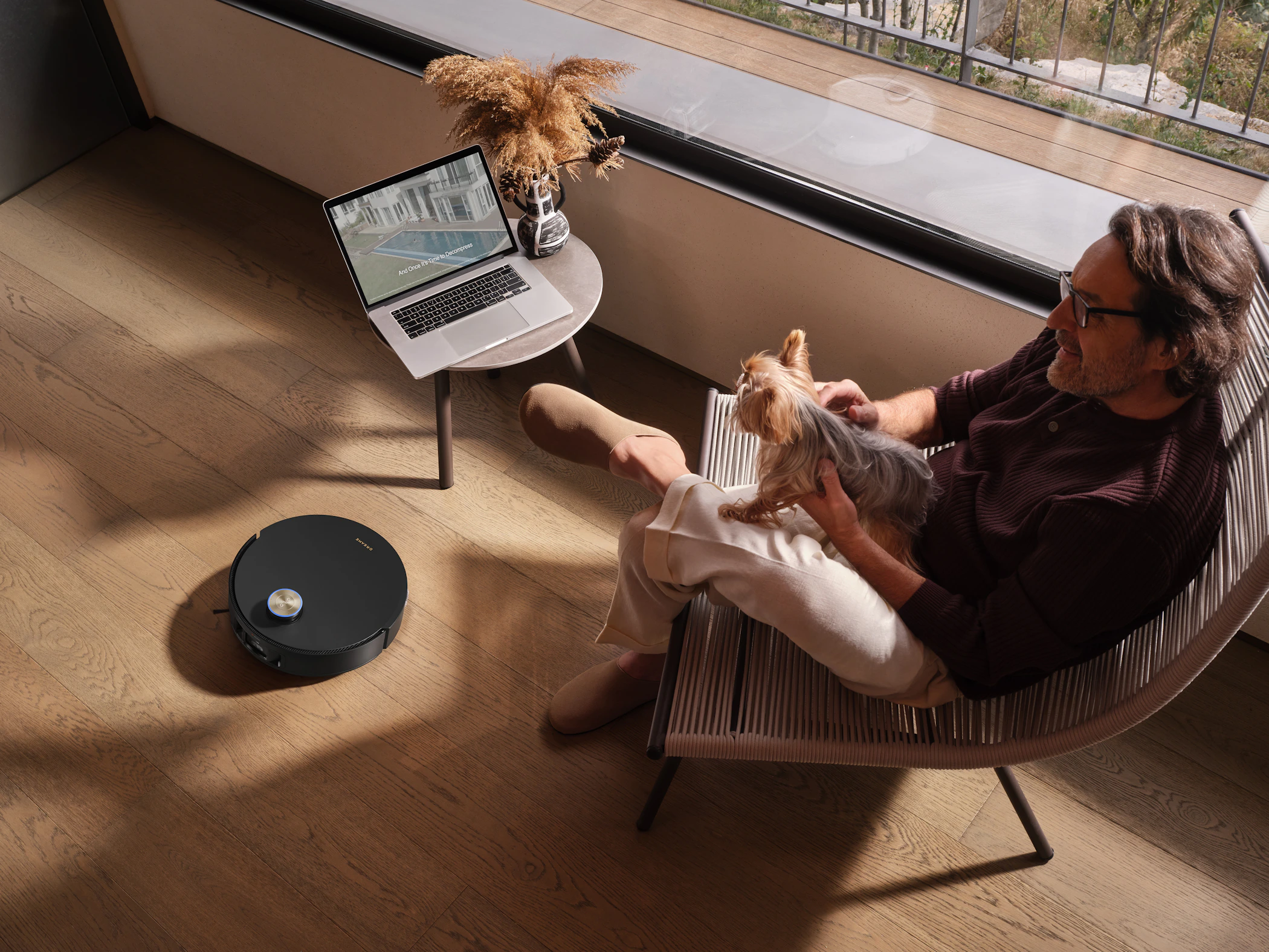 Pet owner relaxing with a small dog in a warm modern home
