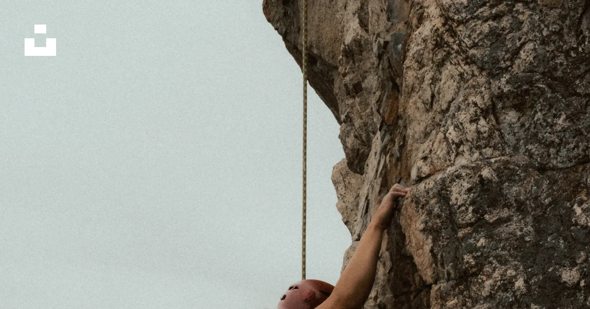 A person rock climbing a steep cliff face photo – Free Woman Image on ...