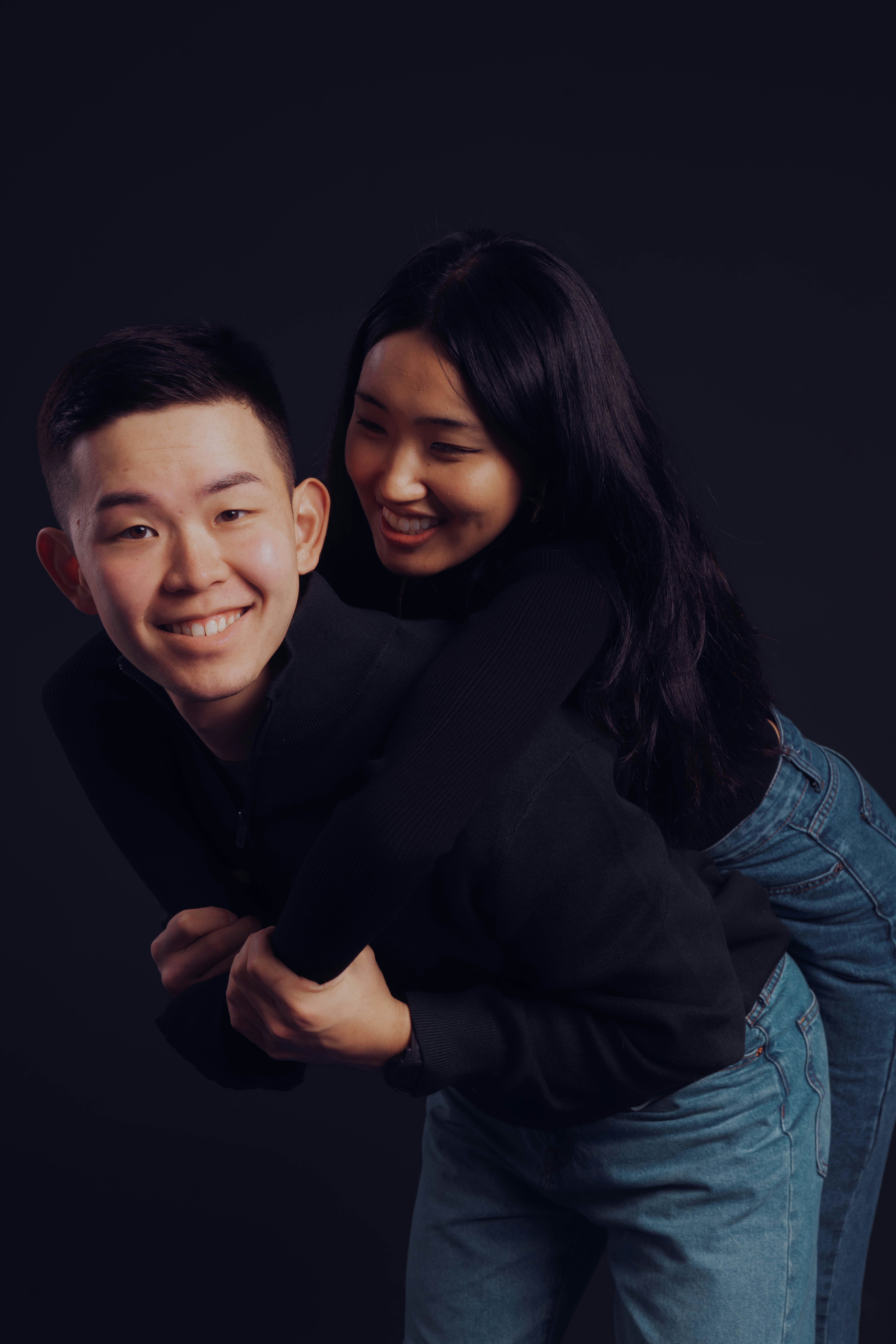 Couple embracing against a dark background