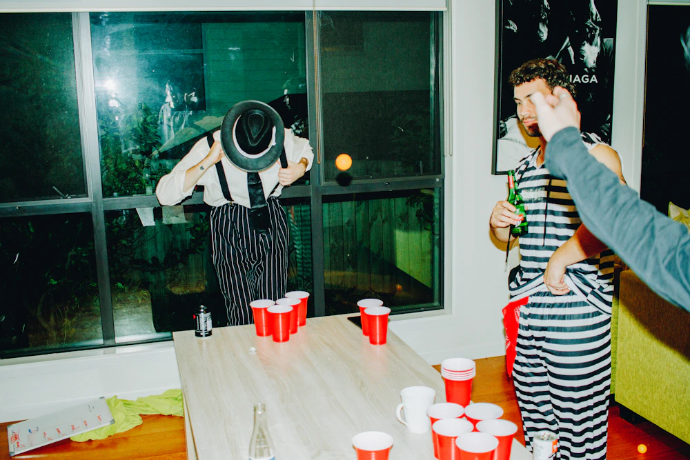 Friends playing beer pong at a party