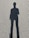Shadow of a person standing on asphalt ground.