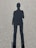Shadow of a person standing on asphalt ground.