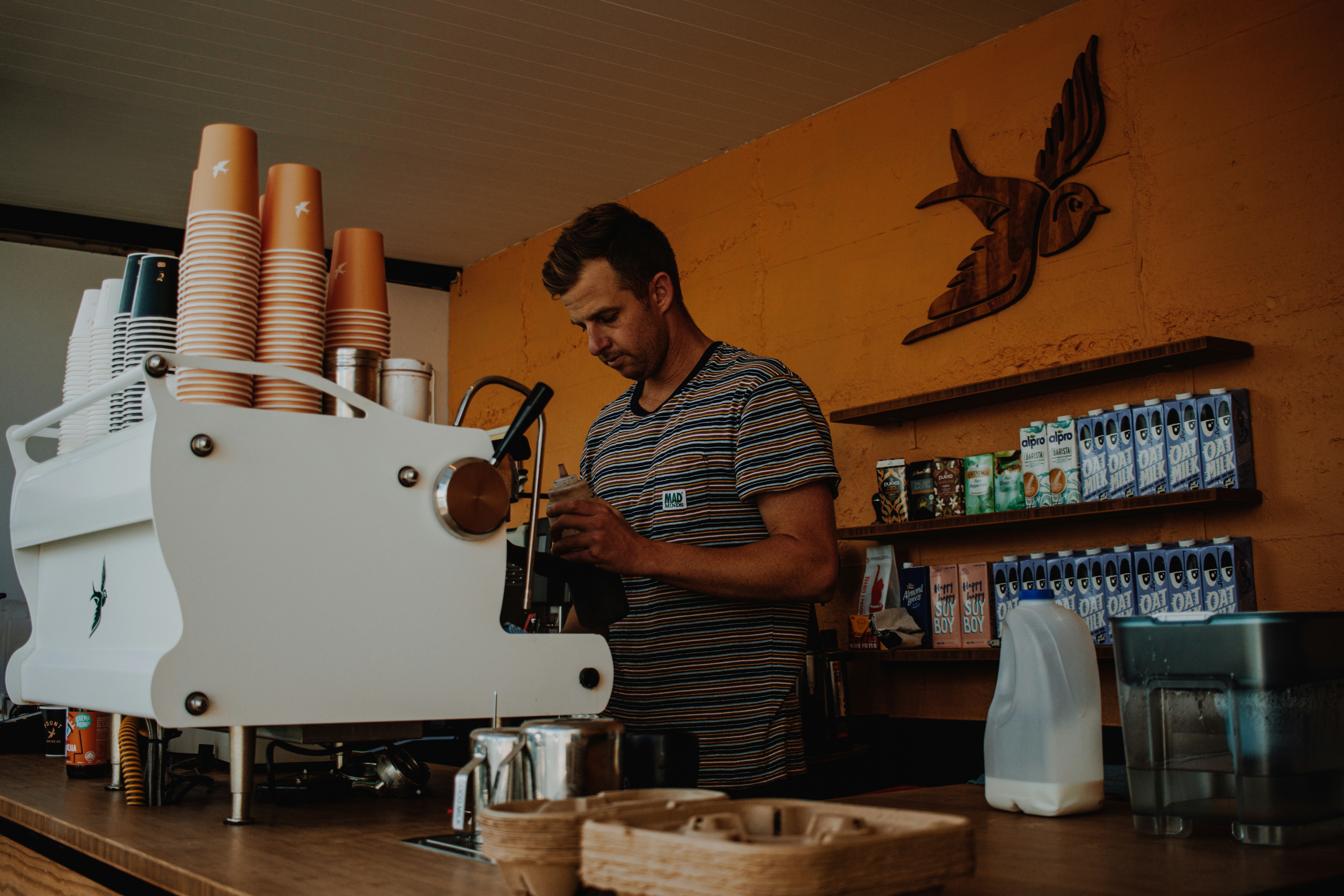 Barista at an espresso machine in a cafe