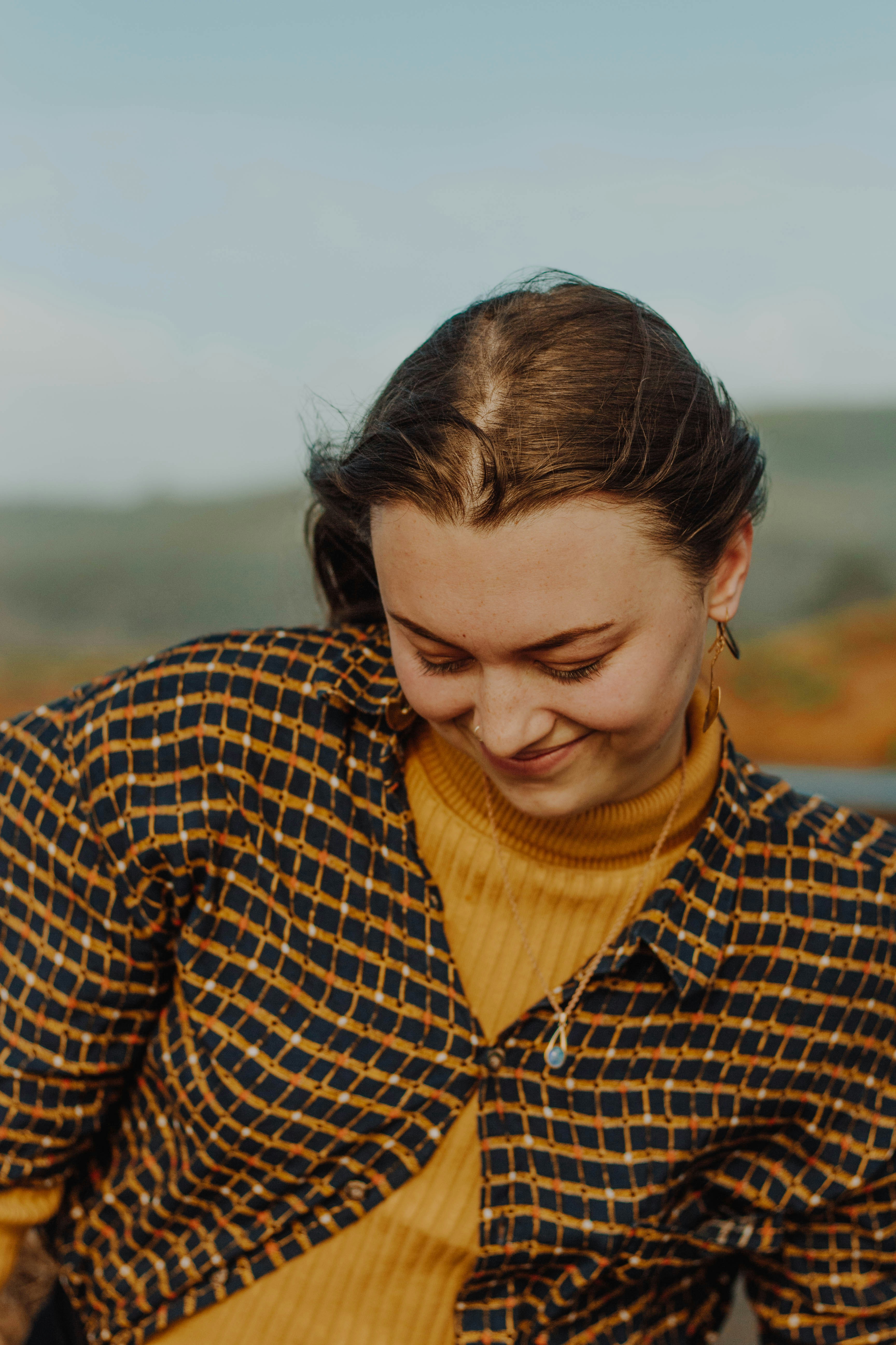 Young woman wearing a plaid shirt and turtleneck