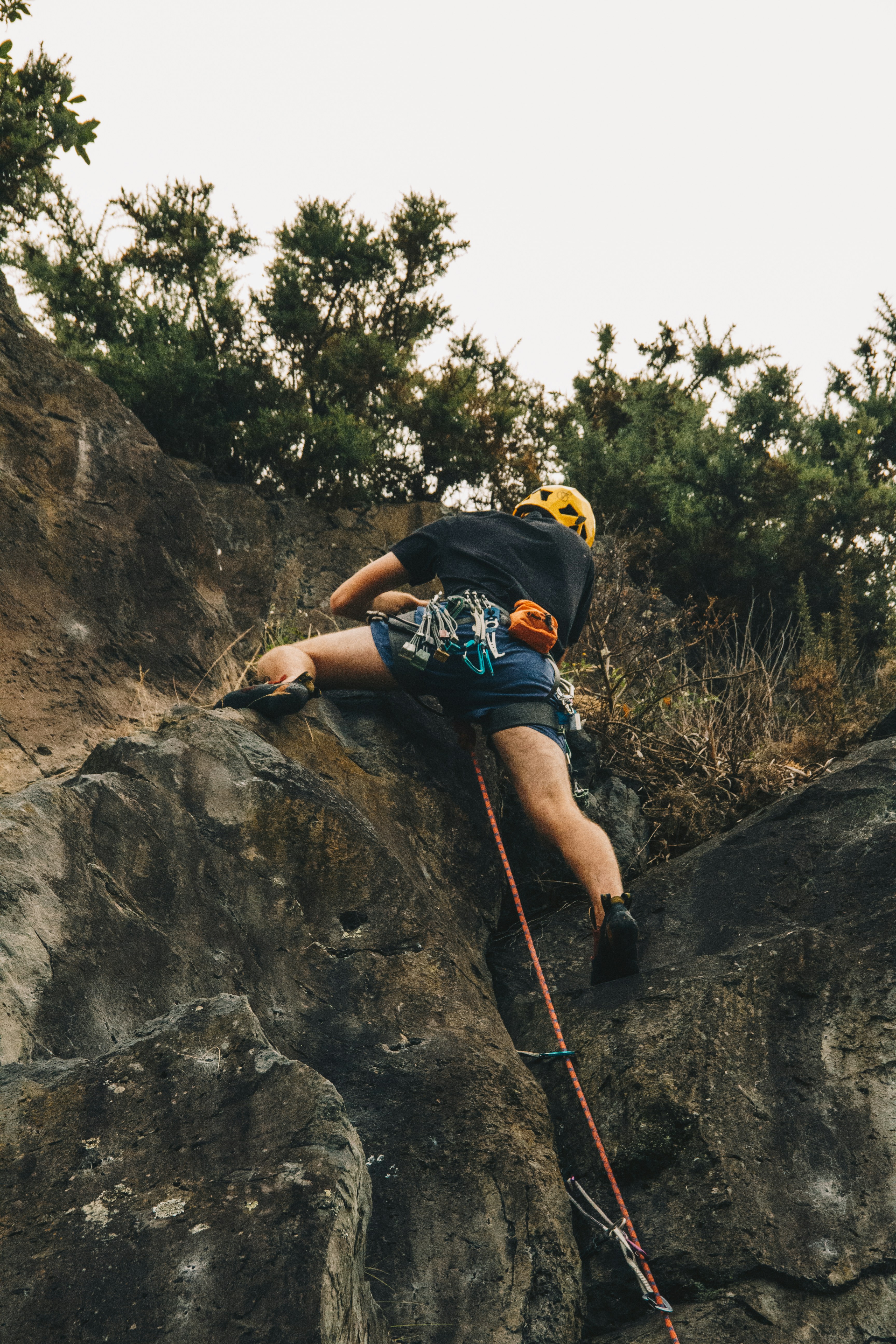 A person rock climbing up a steep cliff face.