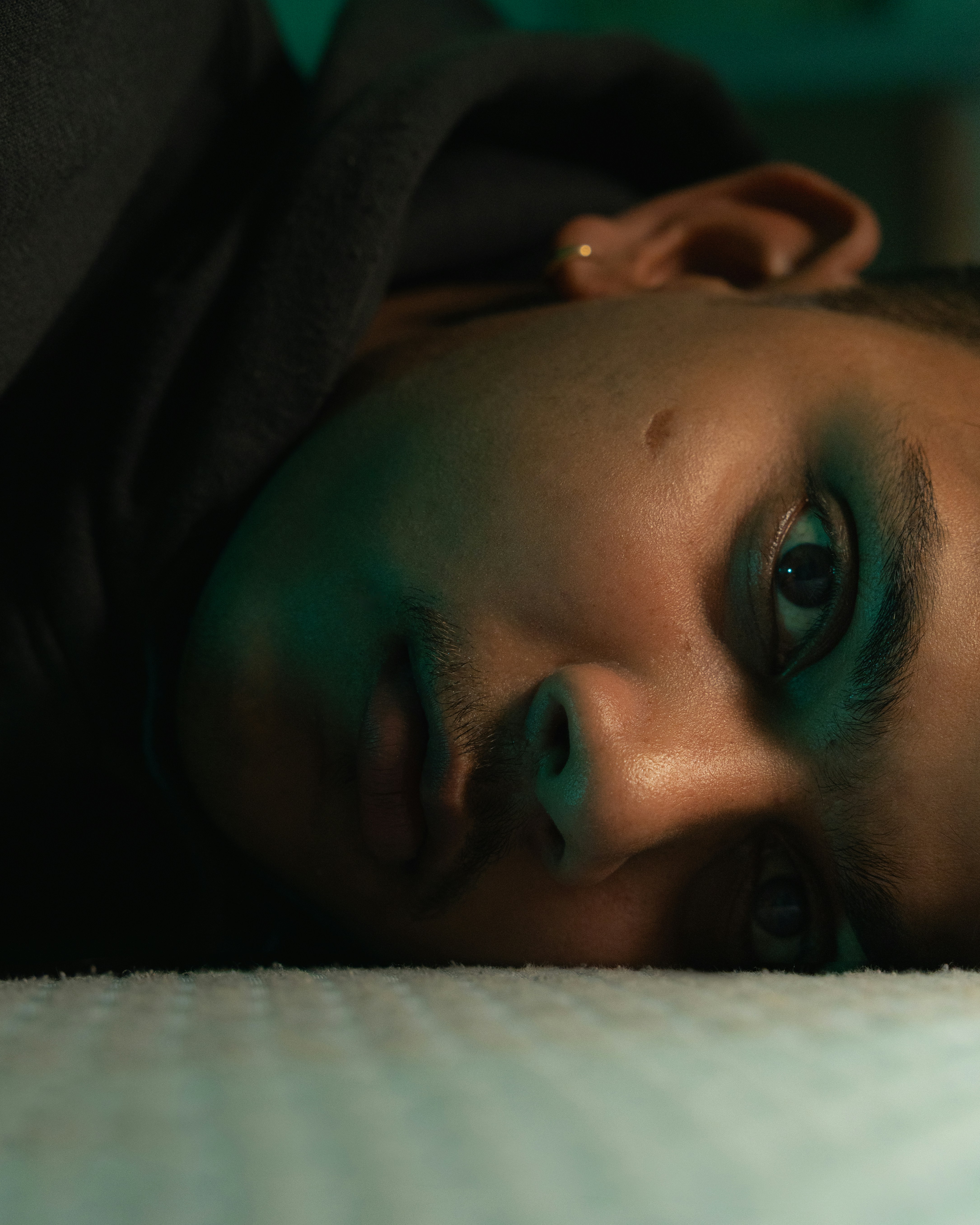 Close-up of a young person's face looking up