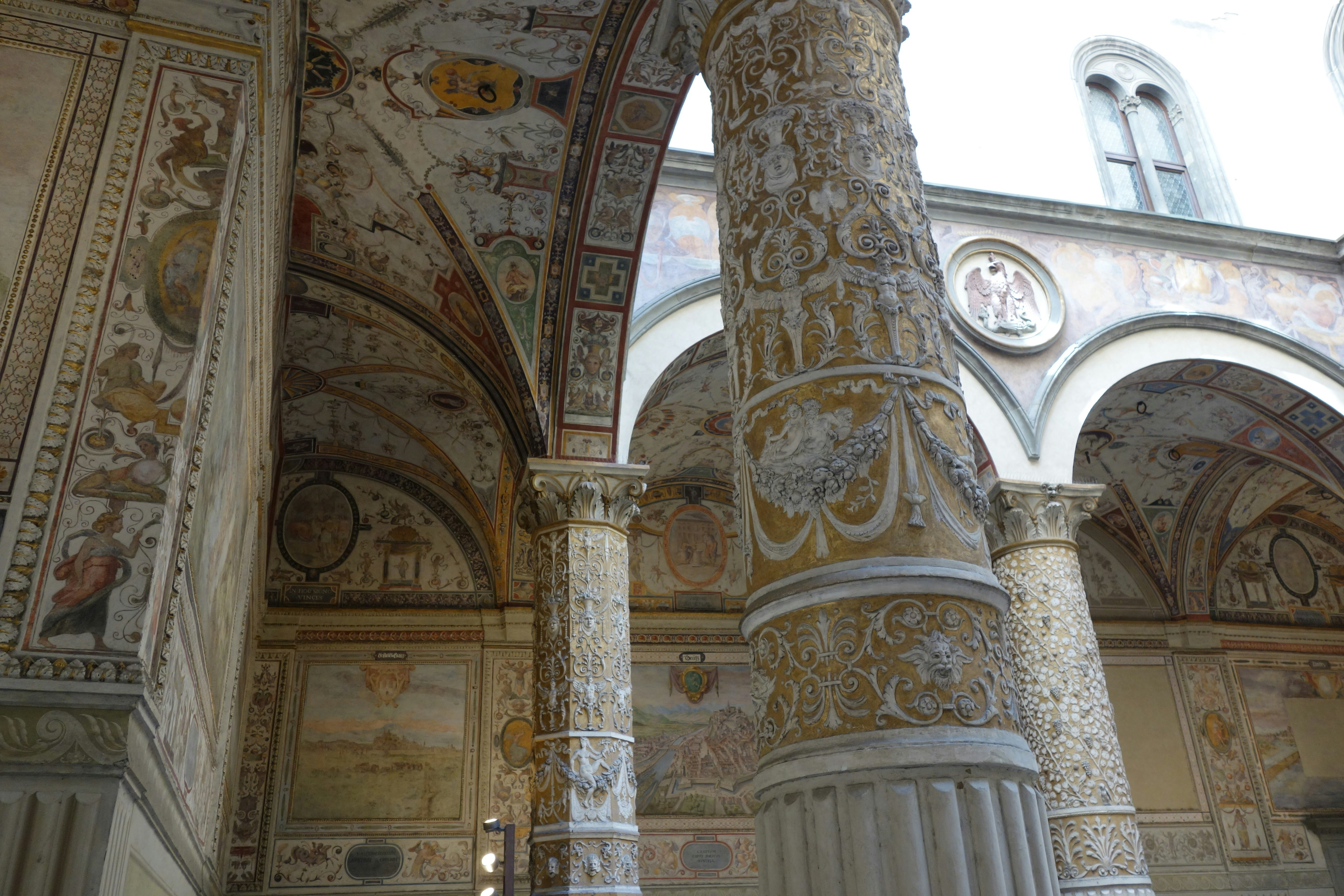 Ornate column and arches in a historic courtyard