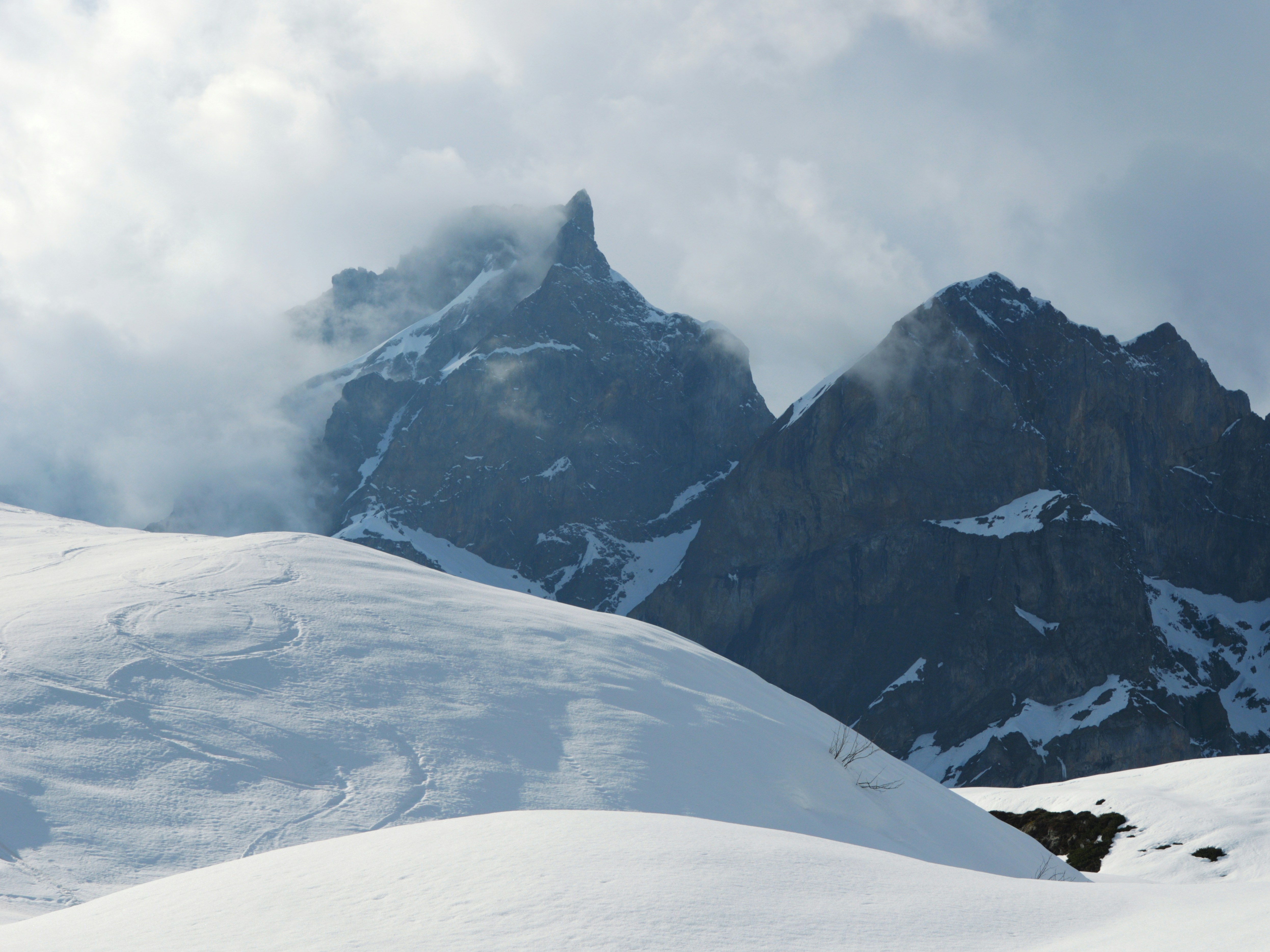 Snowy mountain peaks shrouded in clouds