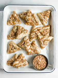 Triangular pastries topped with nuts and caramel