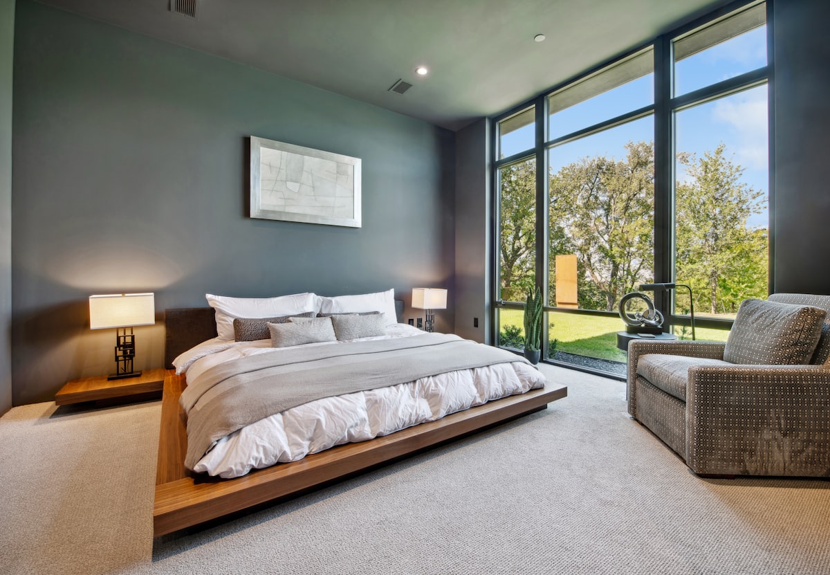 Modern bedroom with bright lawn view