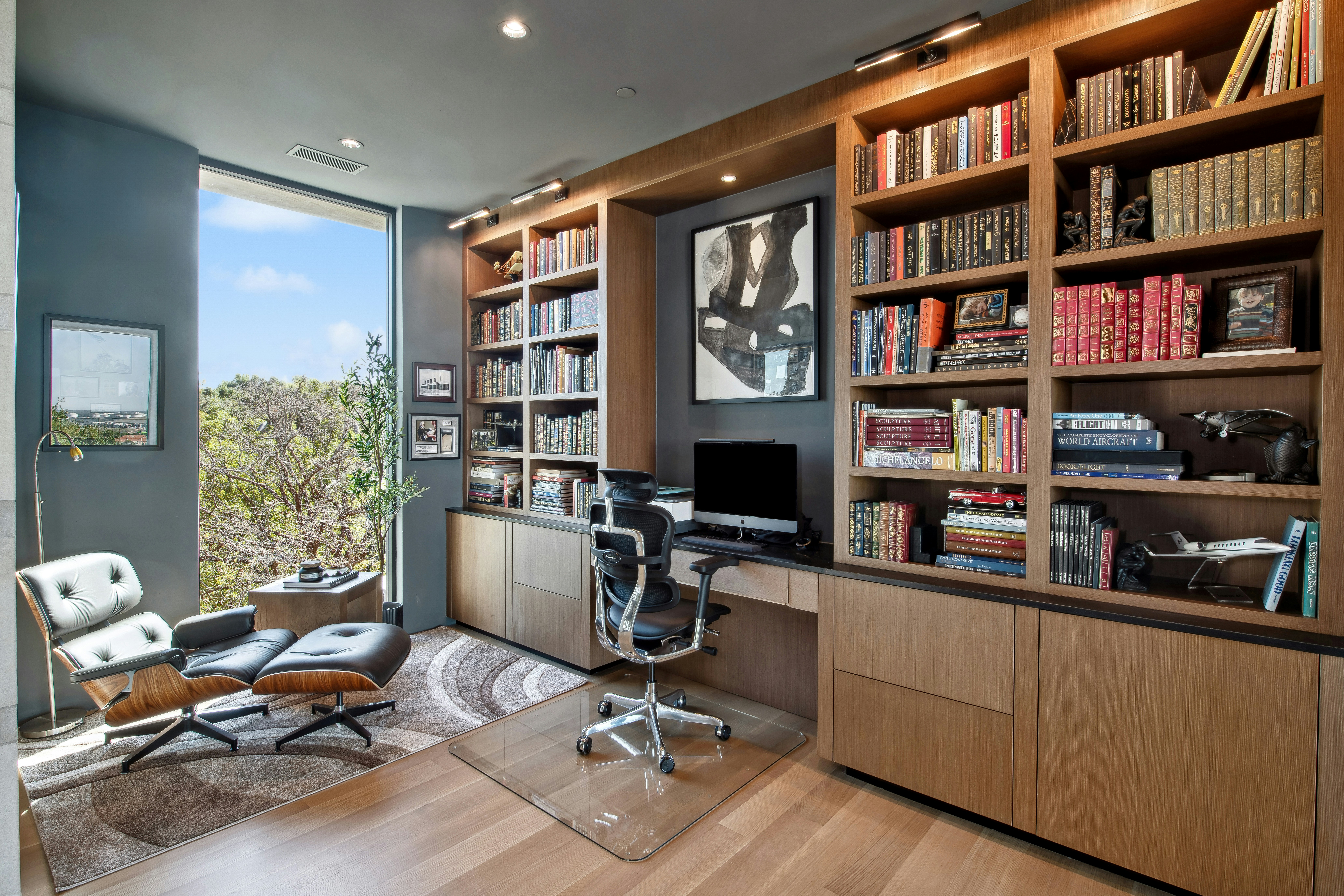 Modern home office with large bookshelves and desk