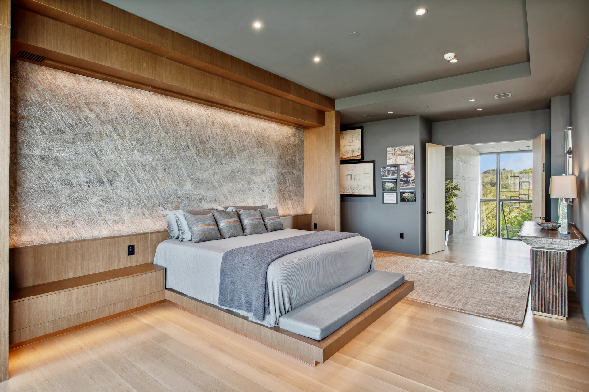 Modern bedroom with a large bed and textured wall.