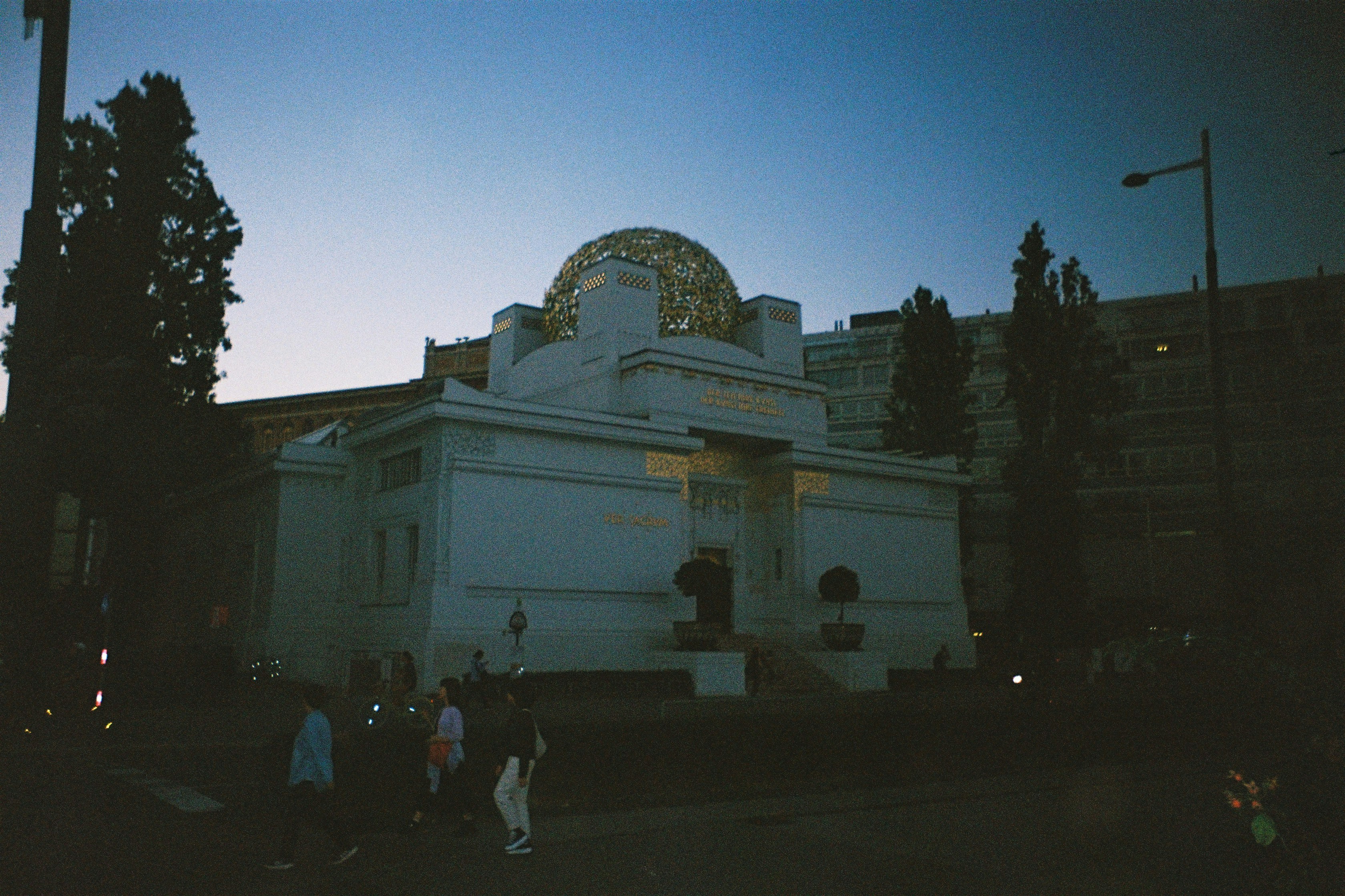 White building with golden dome at dusk