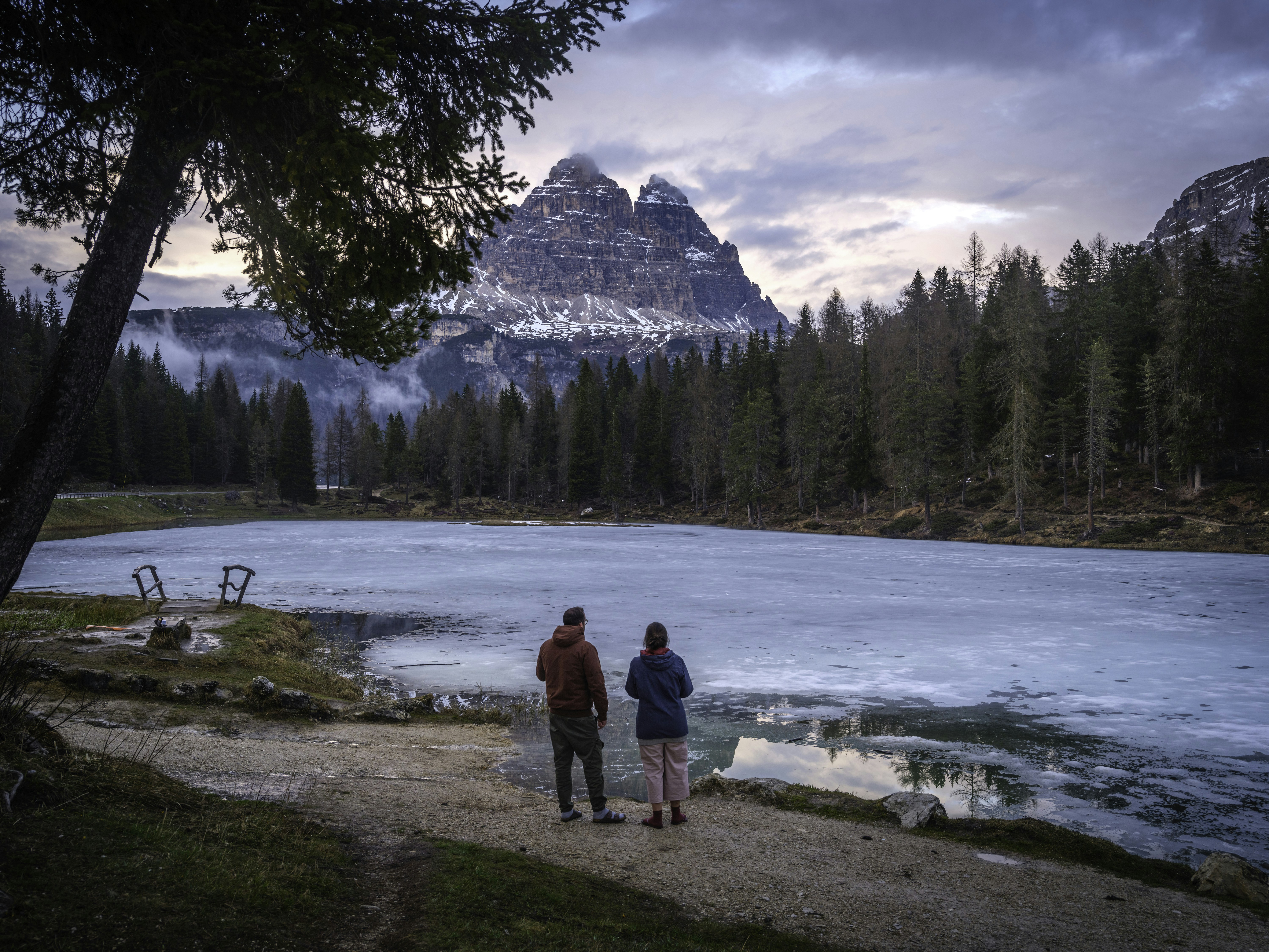 Paar bewundert gefrorenen See und schneebedeckte Berge