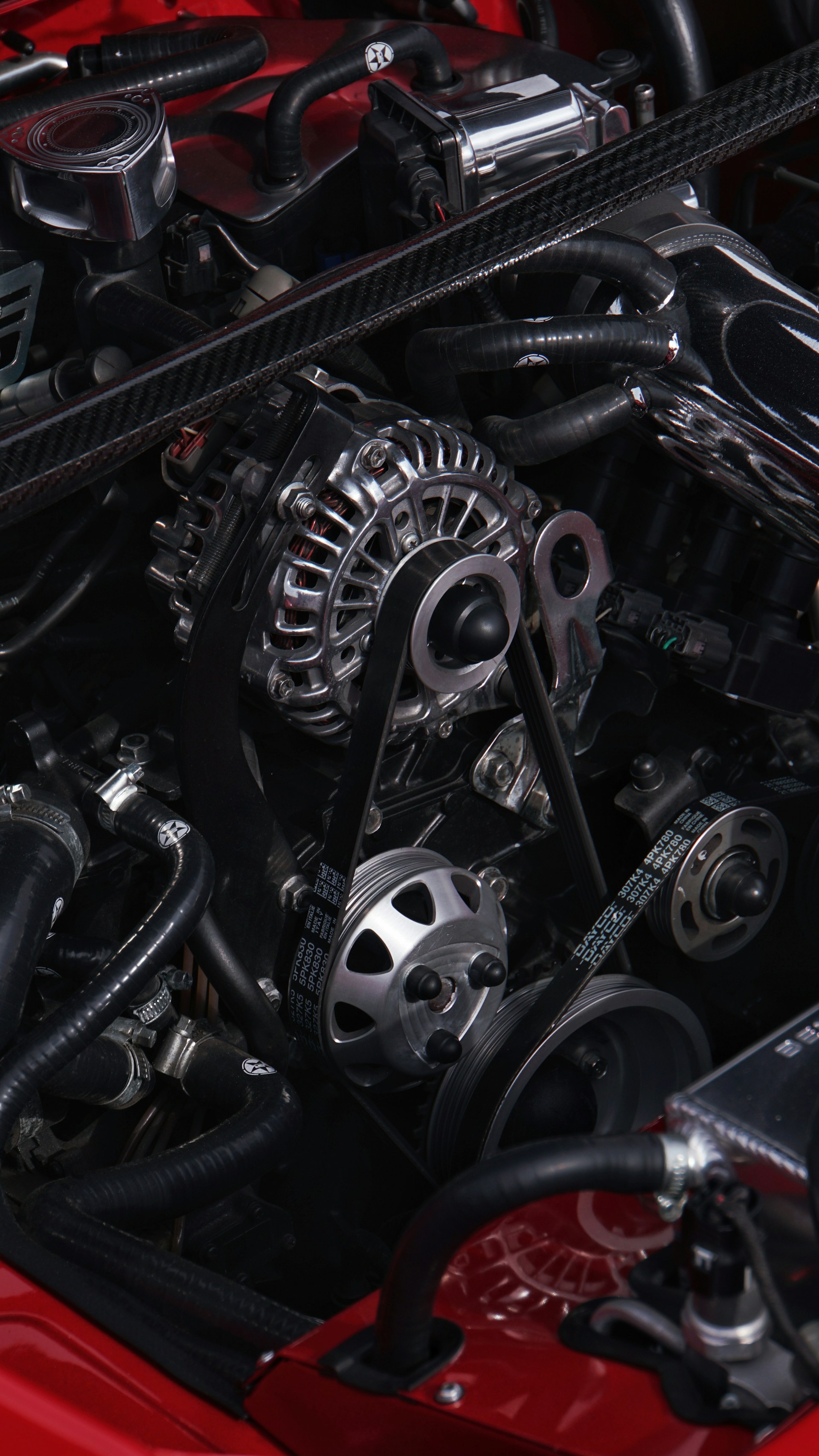 Close-up of a car's engine with chrome alternator.