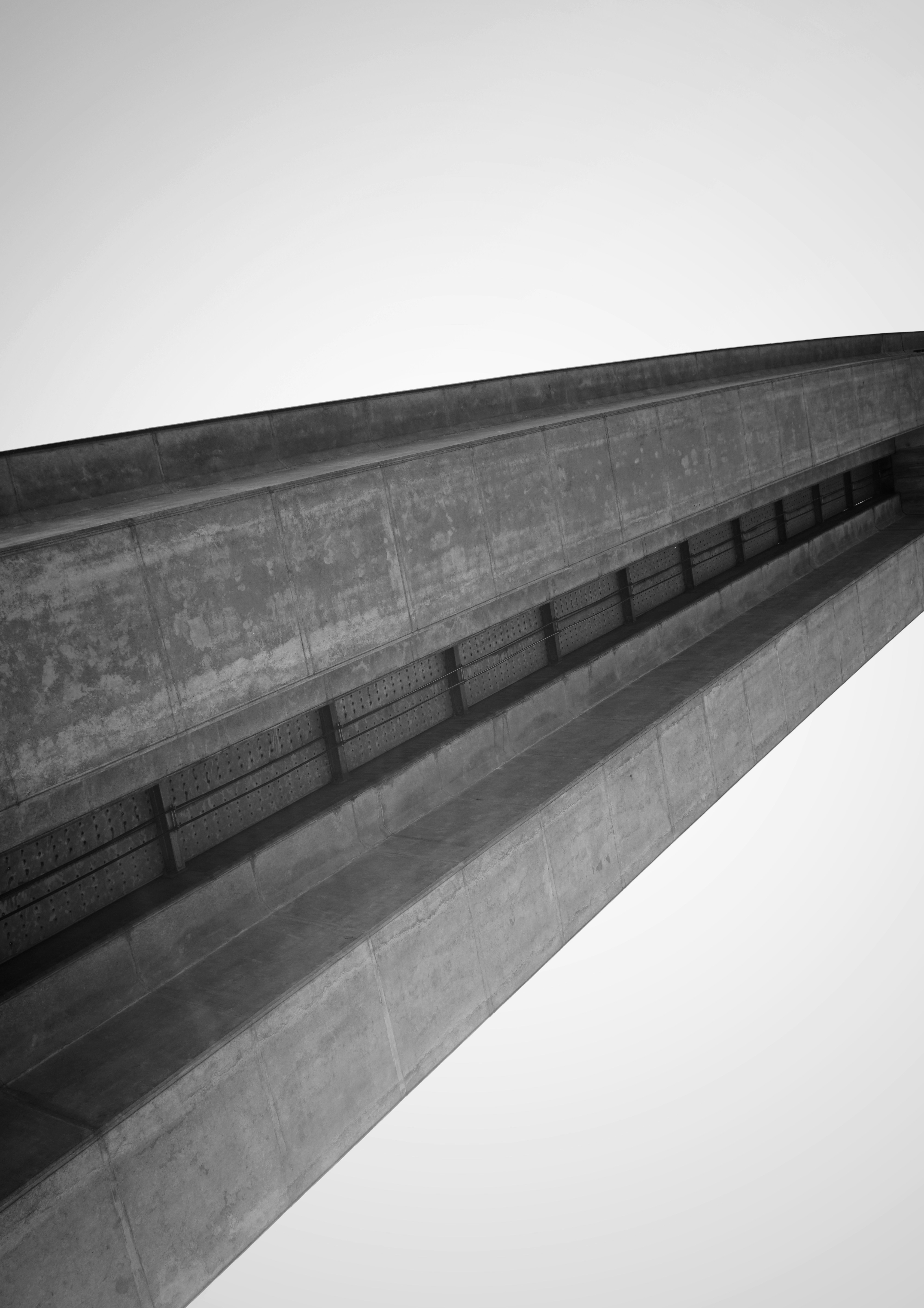 Looking up at a concrete bridge structure against sky