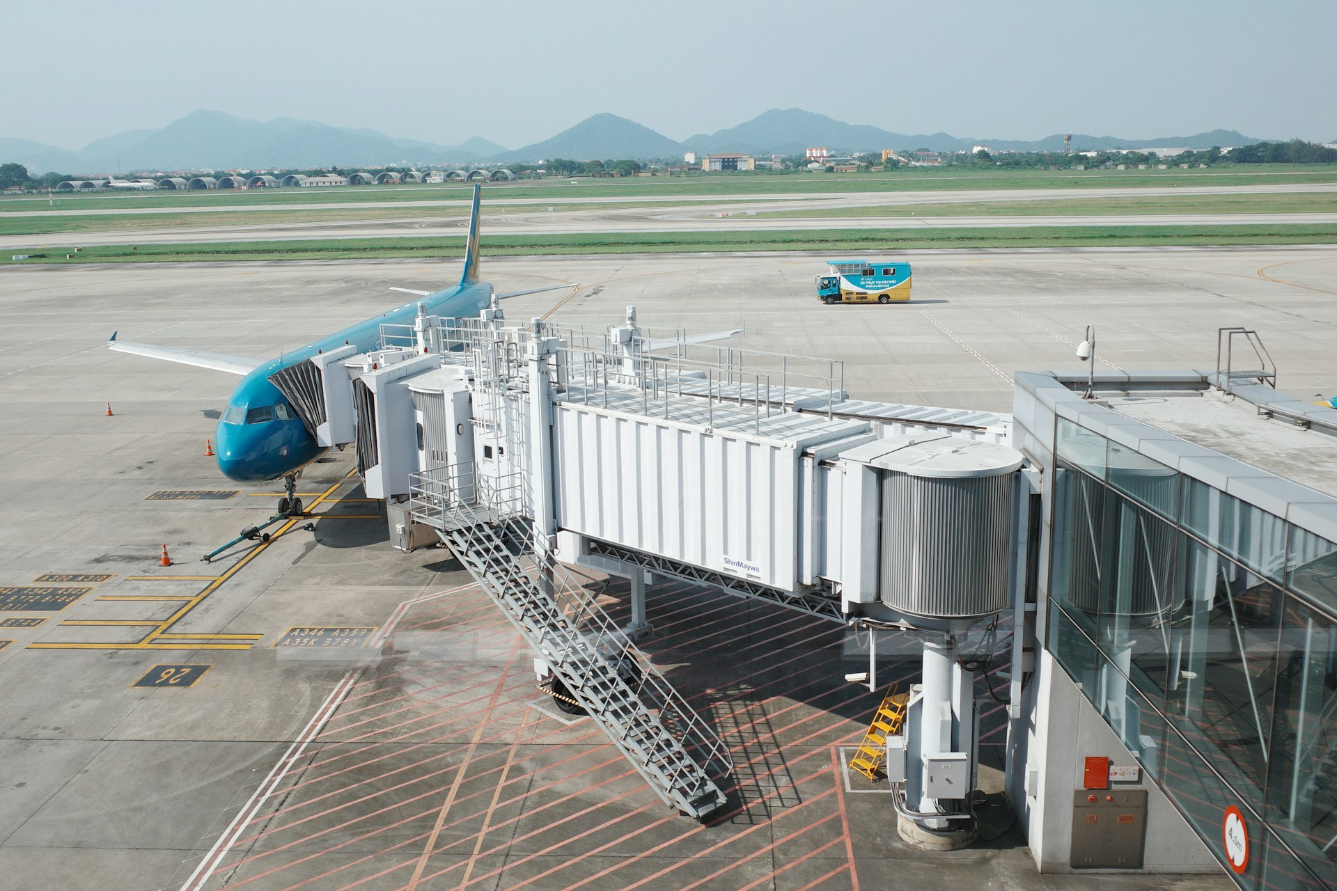 Airplane connected to a jet bridge at airport.