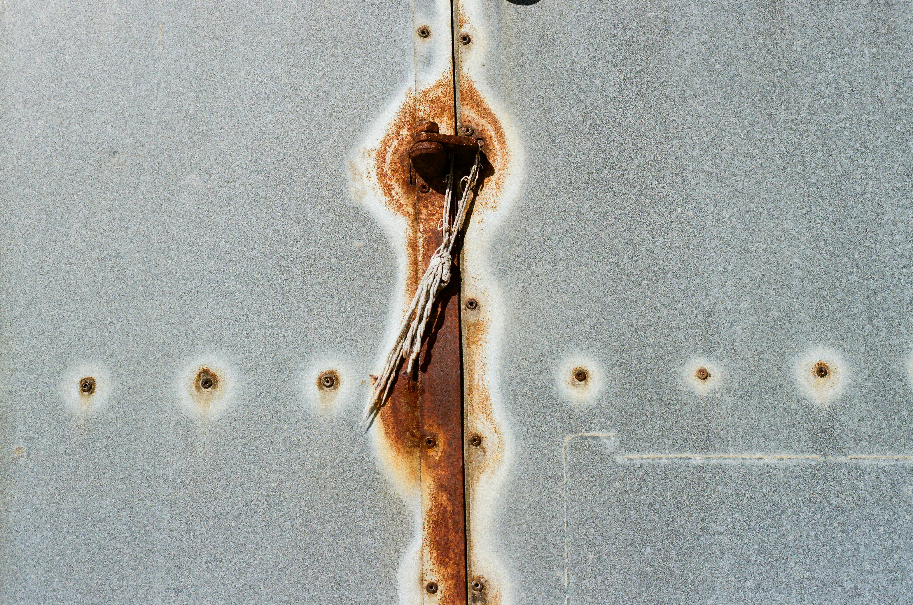 Close-up of rusted metal with rivets