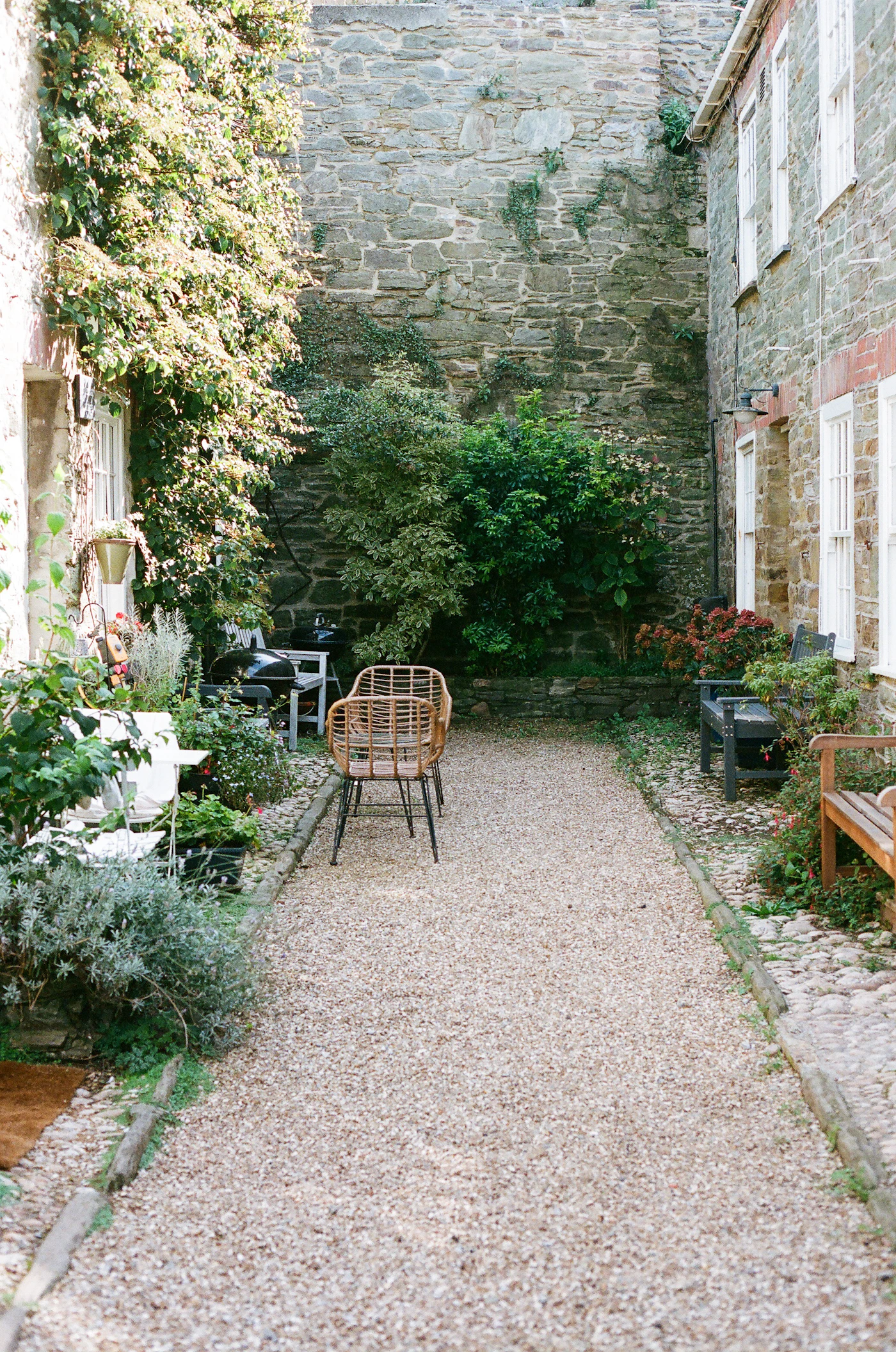 Enclosed courtyard with stone walls and potted plants