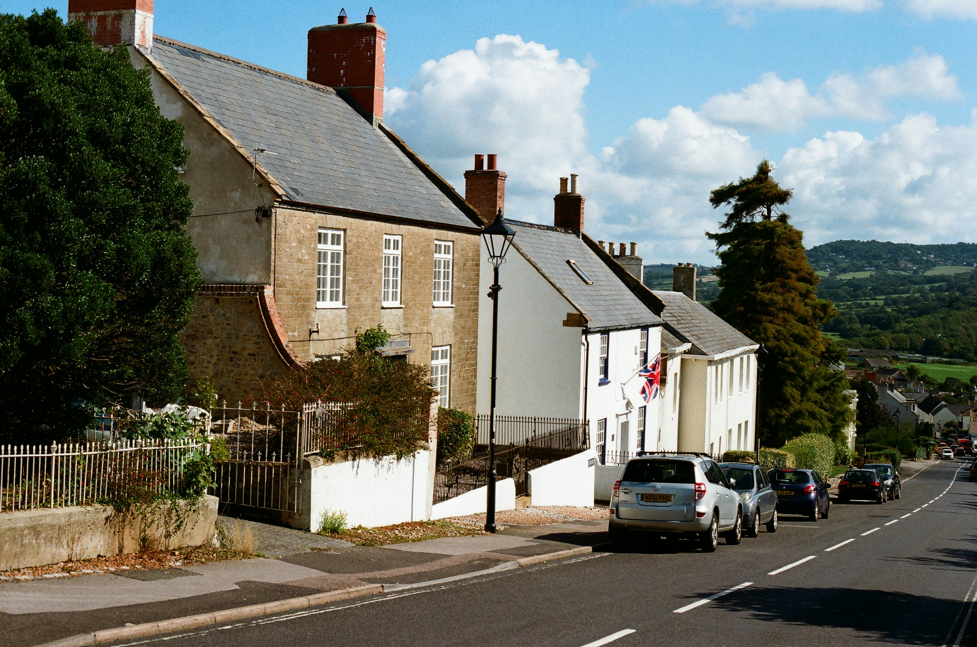  Two individuals, possibly a homeowner and a tax professional, intensely reviewing property tax documents and a laptop, discussing figures for a potential appeal.